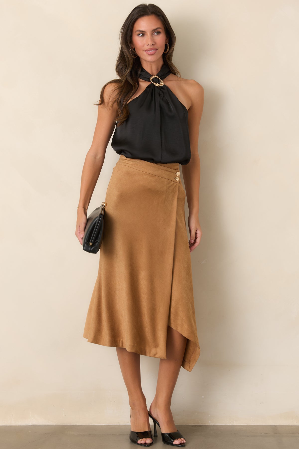 Stretch faux suede shapes the high-rise skirt with a graceful angled hem and polished wrap-front construction.