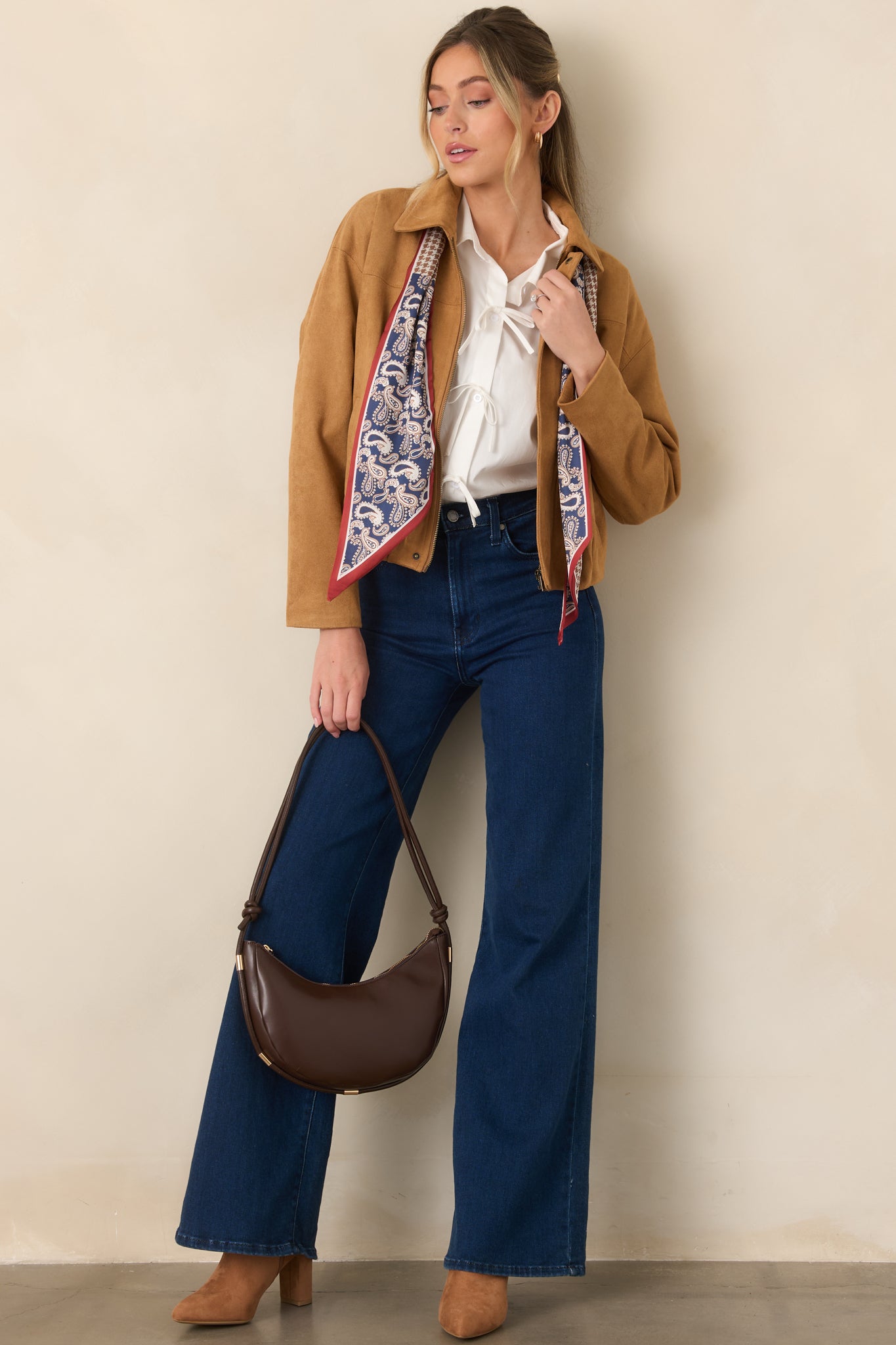 Soft stretch faux suede jacket featuring a pointed collar, dropped shoulders, concealed zip-front closure, subtle seam detailing, and a gathered hem.
