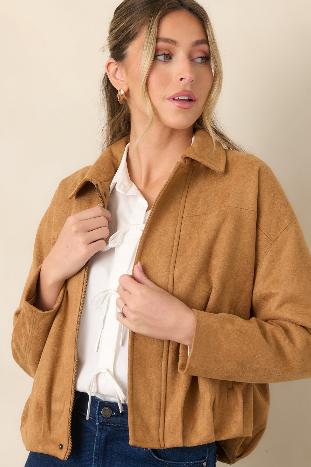 Stretch faux suede jacket detail showcasing the softly gathered hem and relaxed blouson shape.