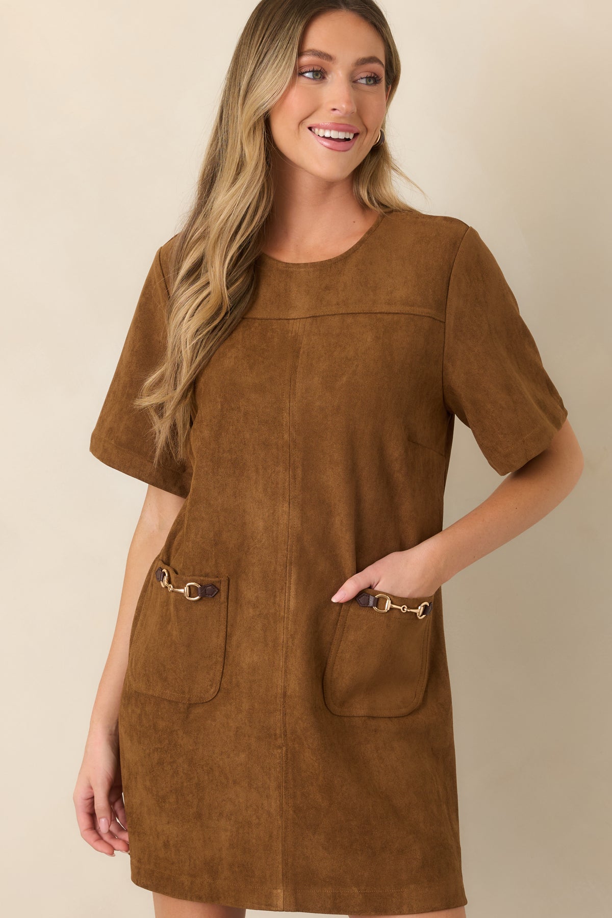 Stretch faux suede dress showcasing the front patch pockets and ornate gold-tone horsebit detailing.