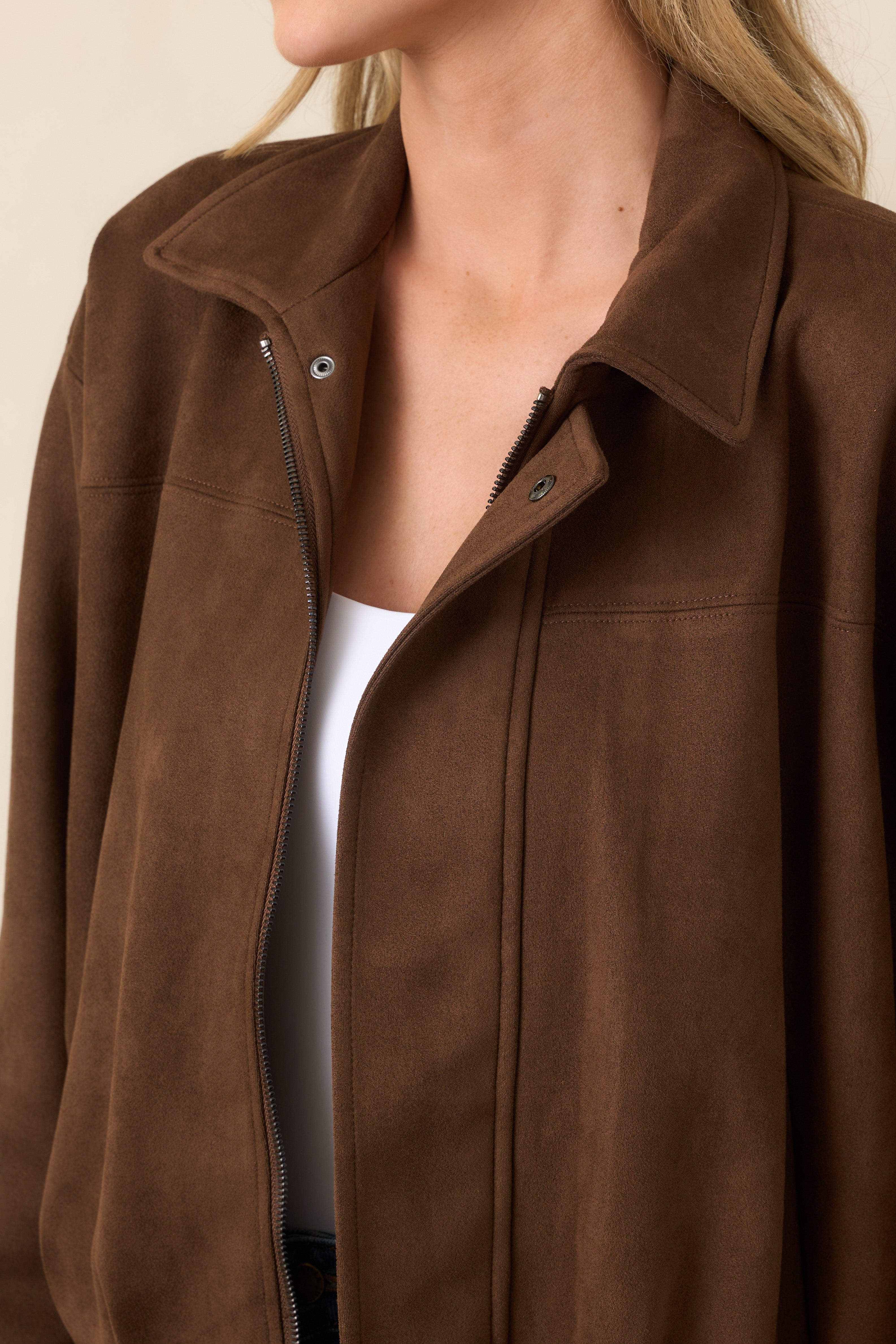 Close-up of the soft stretch faux suede fabric with subtle seam detailing and clean, polished construction.
