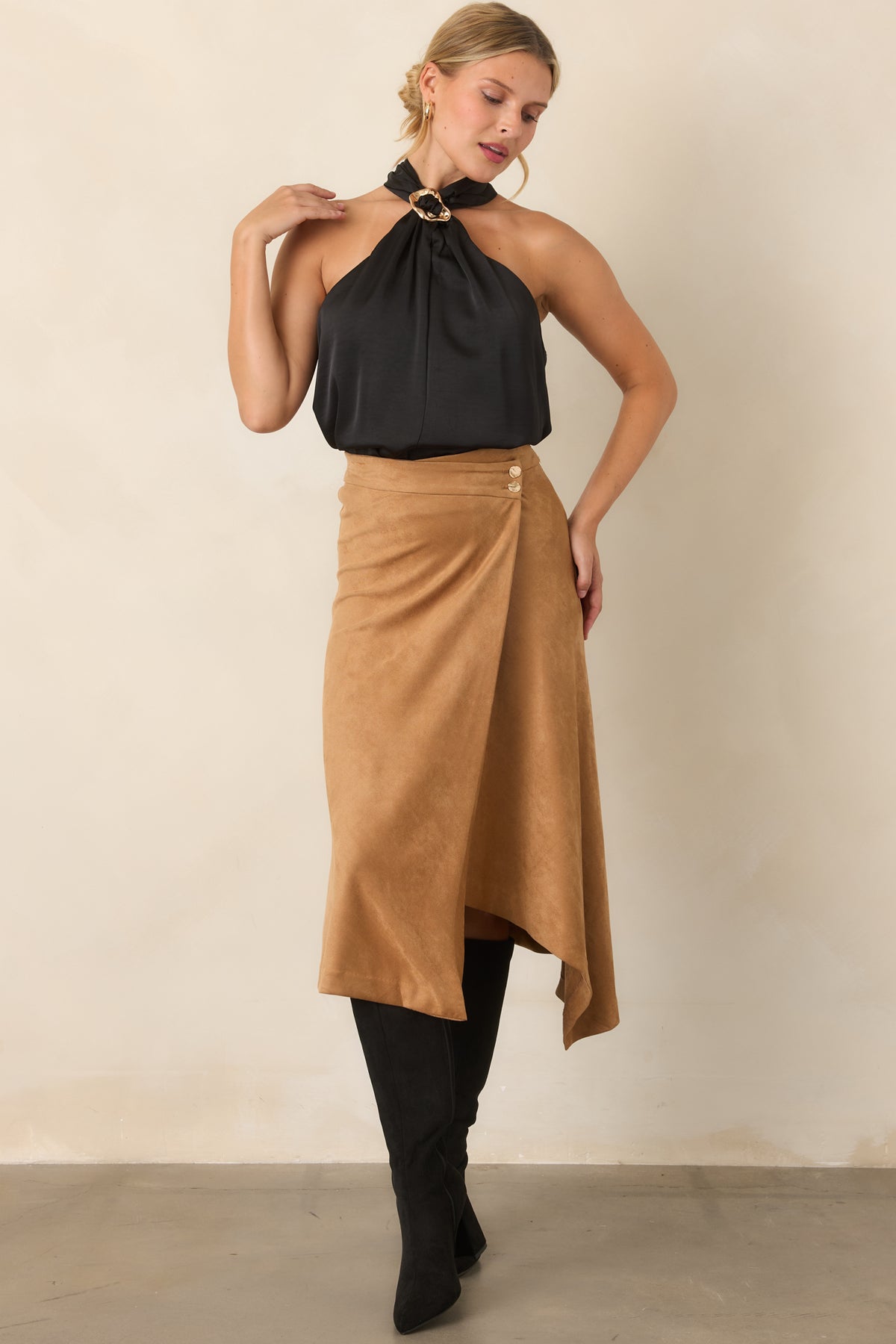 Stretch faux suede skirt featuring an angled hem and two hammered gold-tone buttons.