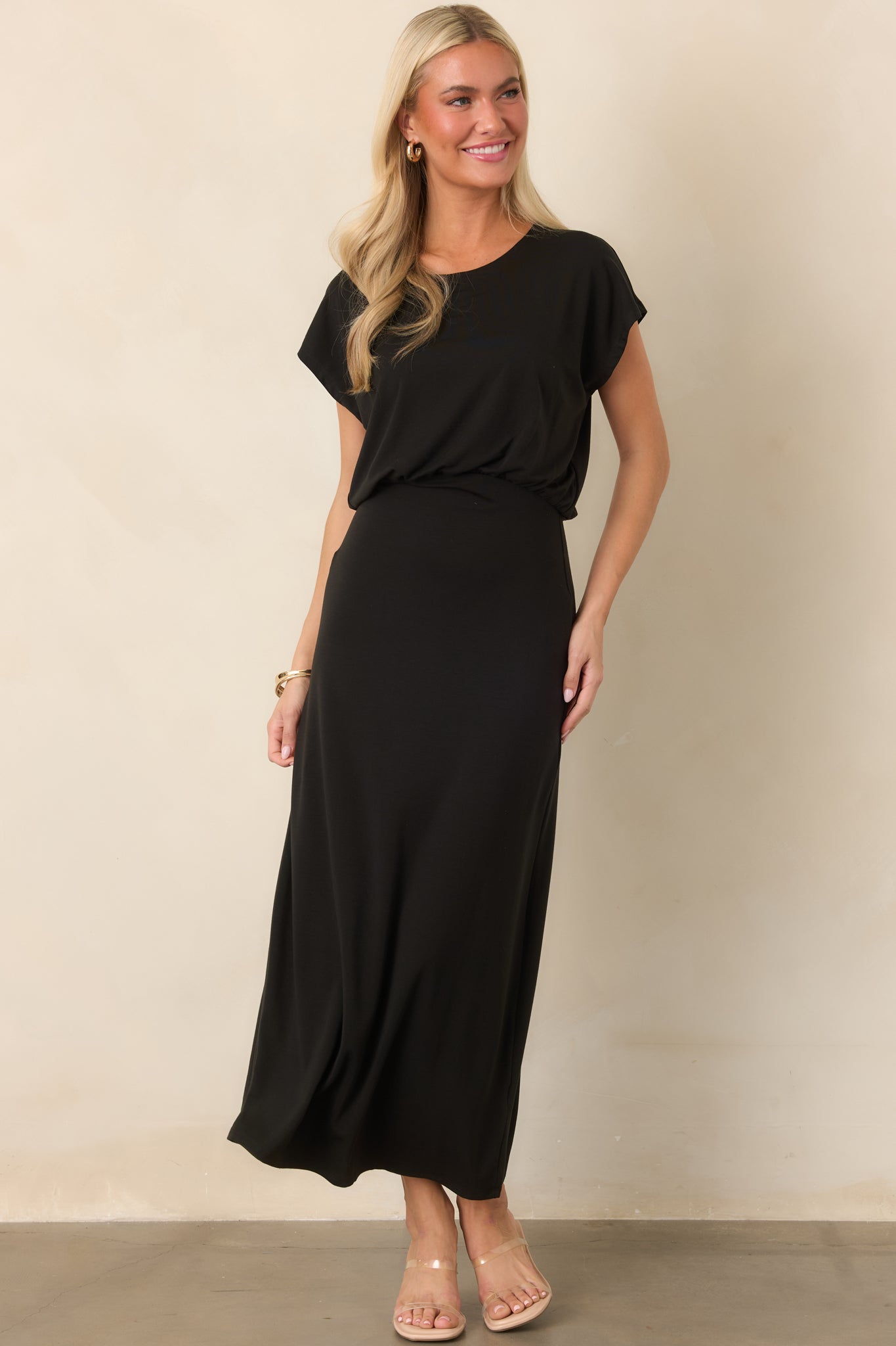 Streamlined stretch jersey dress combining a softly draped bodice with subtle waist gathering and a fluid midi-length skirt.