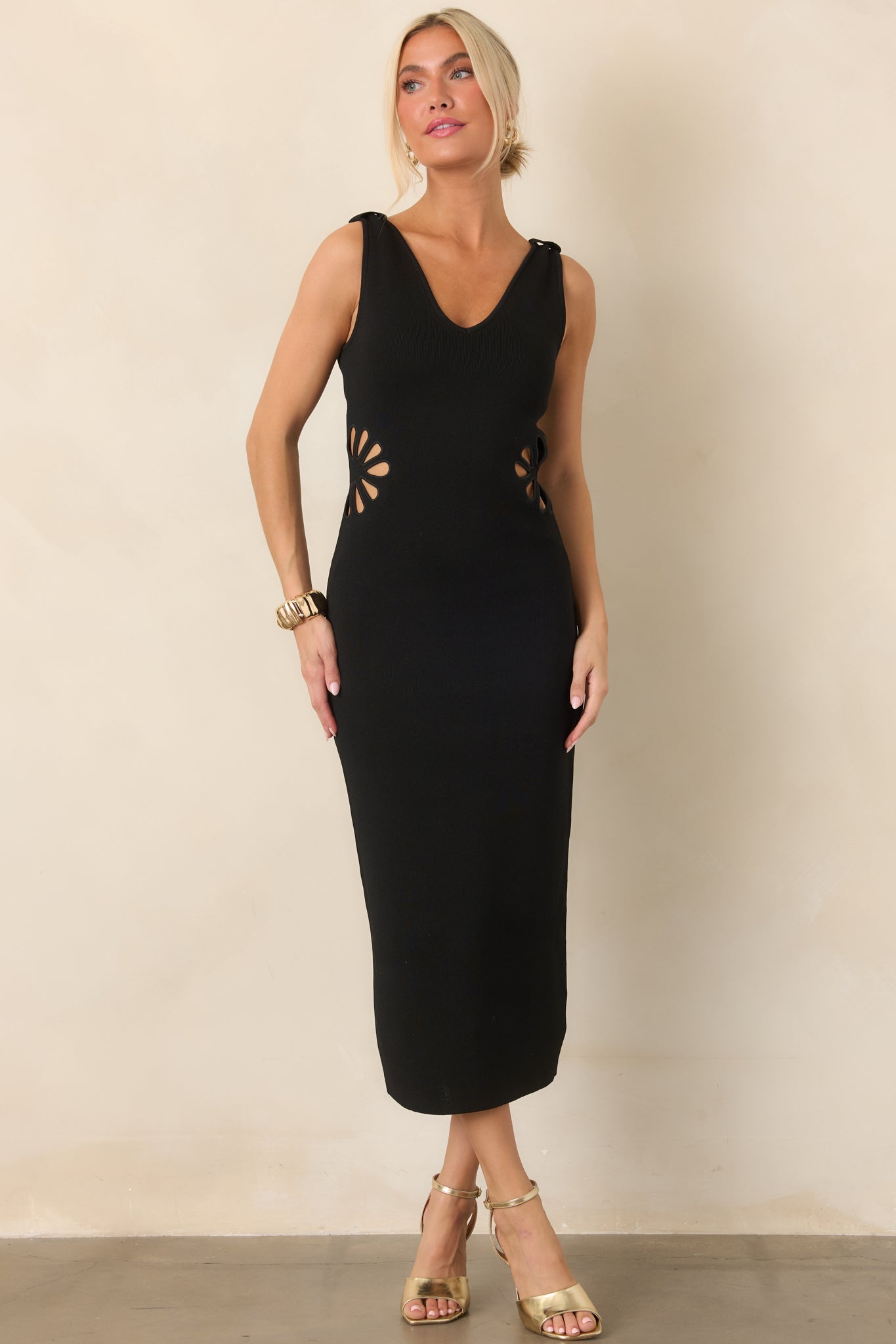 Structured stretch-knit midi dress featuring a V-neckline, wide shoulder straps, sculpted silhouette, and floral-inspired waist cutouts.