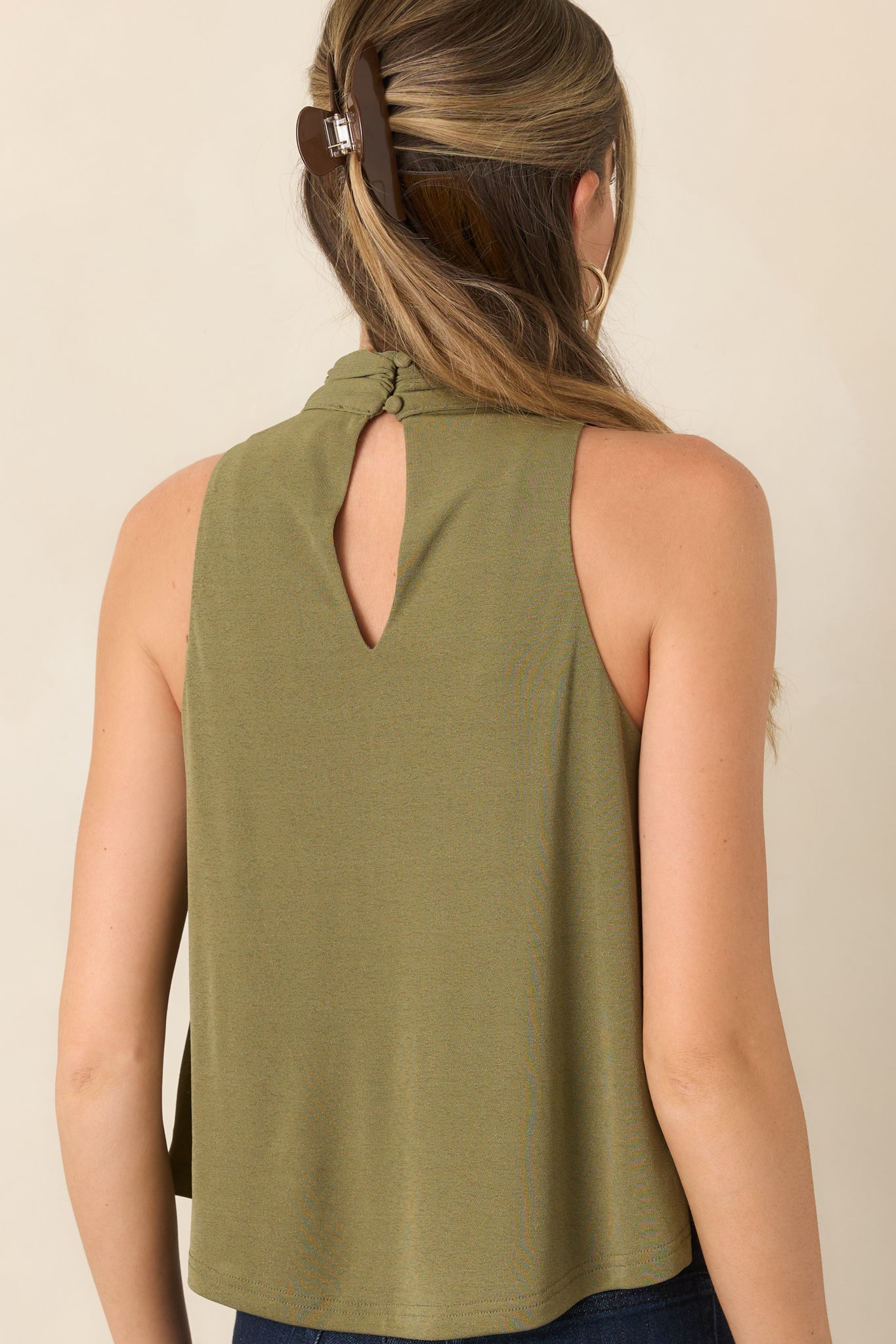 Rear view of the stretch knit top showcasing the relaxed drape and back keyhole with button closures.