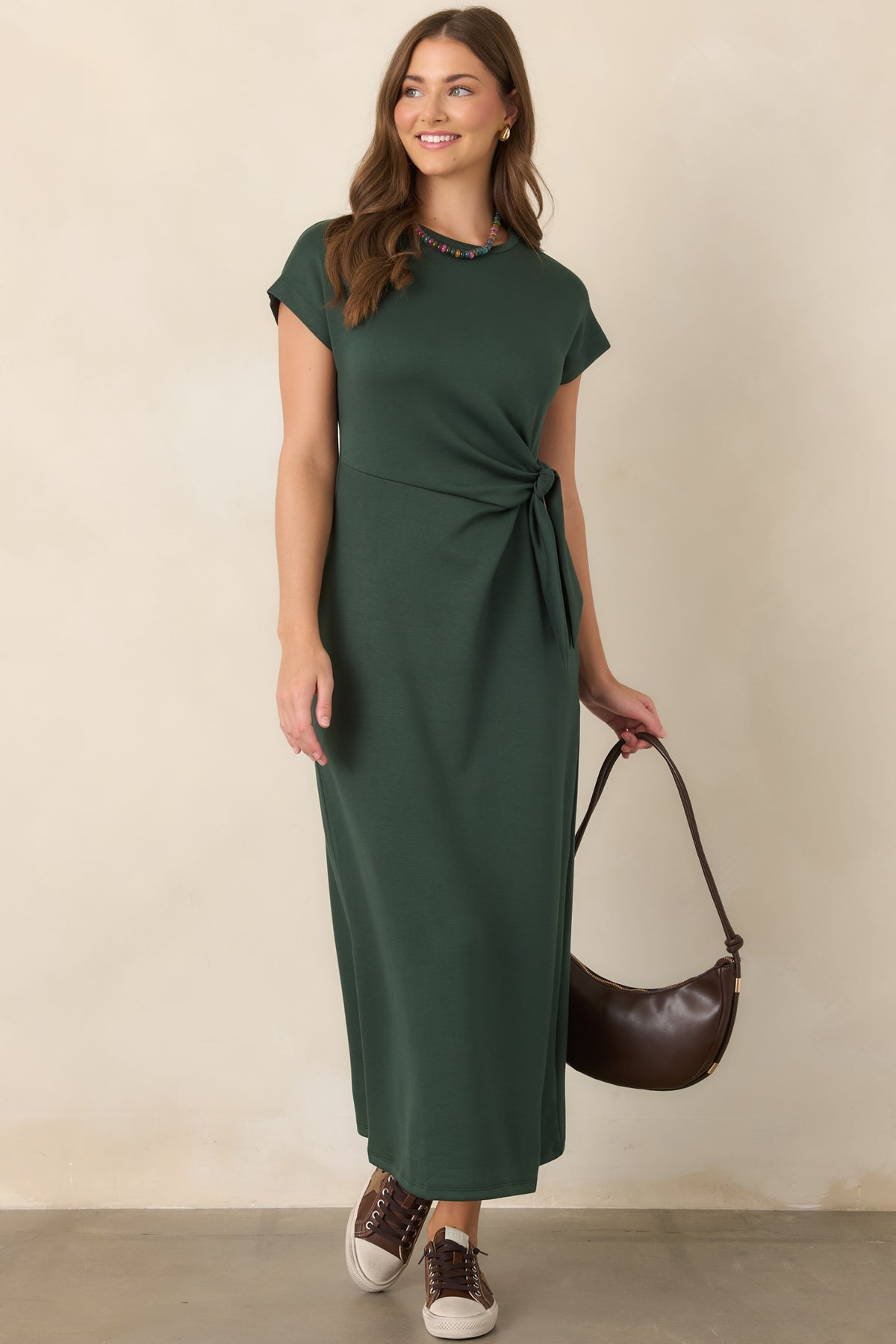 Stretch midi dress showcasing its fluid drape, softly shaped waist, and elegant knot detail that defines the silhouette.