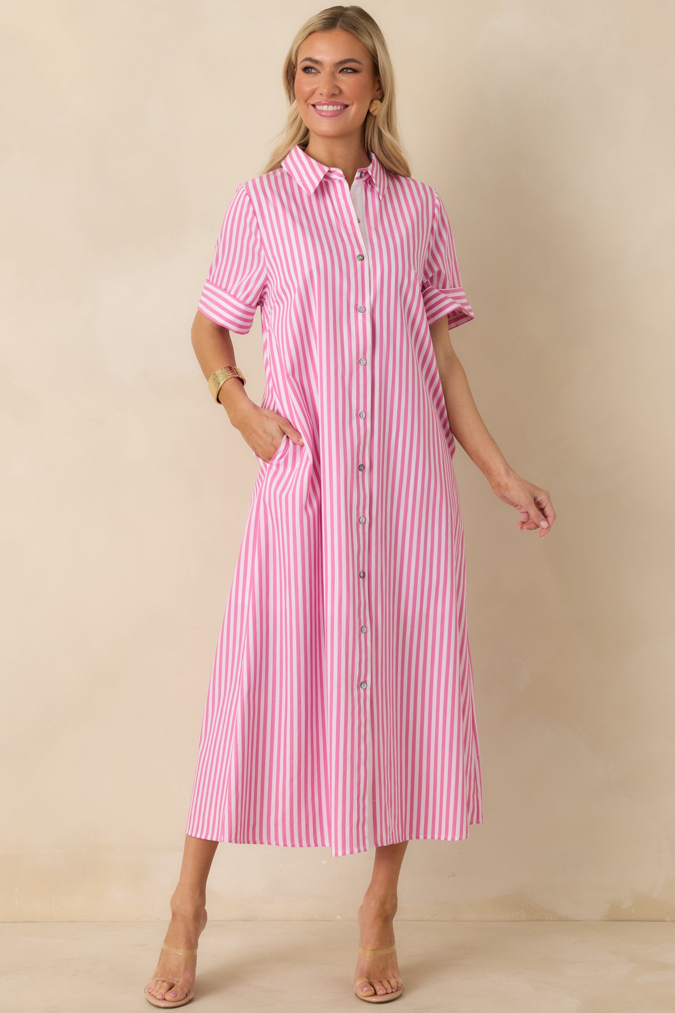 Striped button-up dress in an A-line cut, collared neck, and relaxed fit for effortless styling.