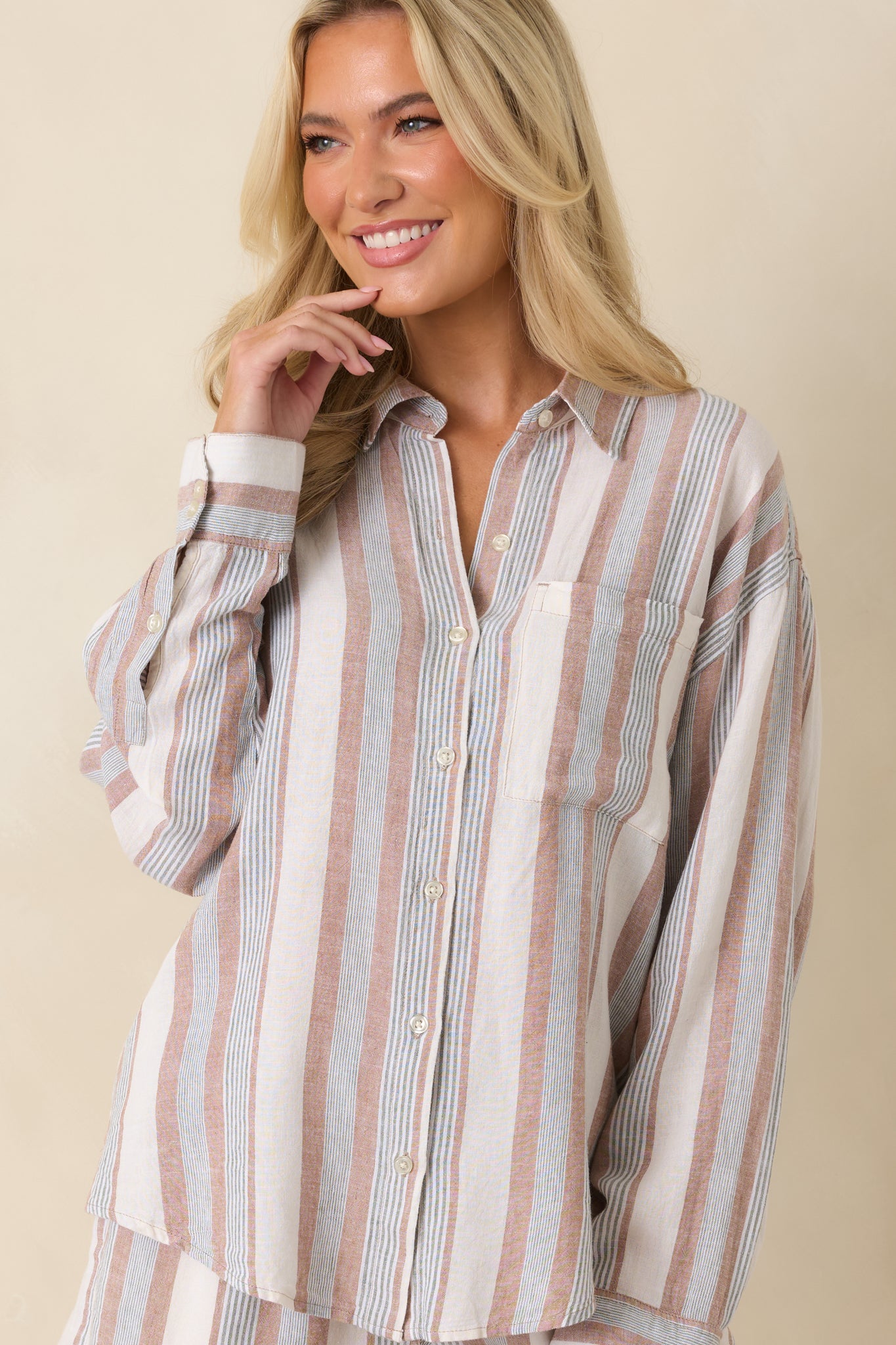 Striped button-up top featuring a chest pocket and softly structured long sleeves.