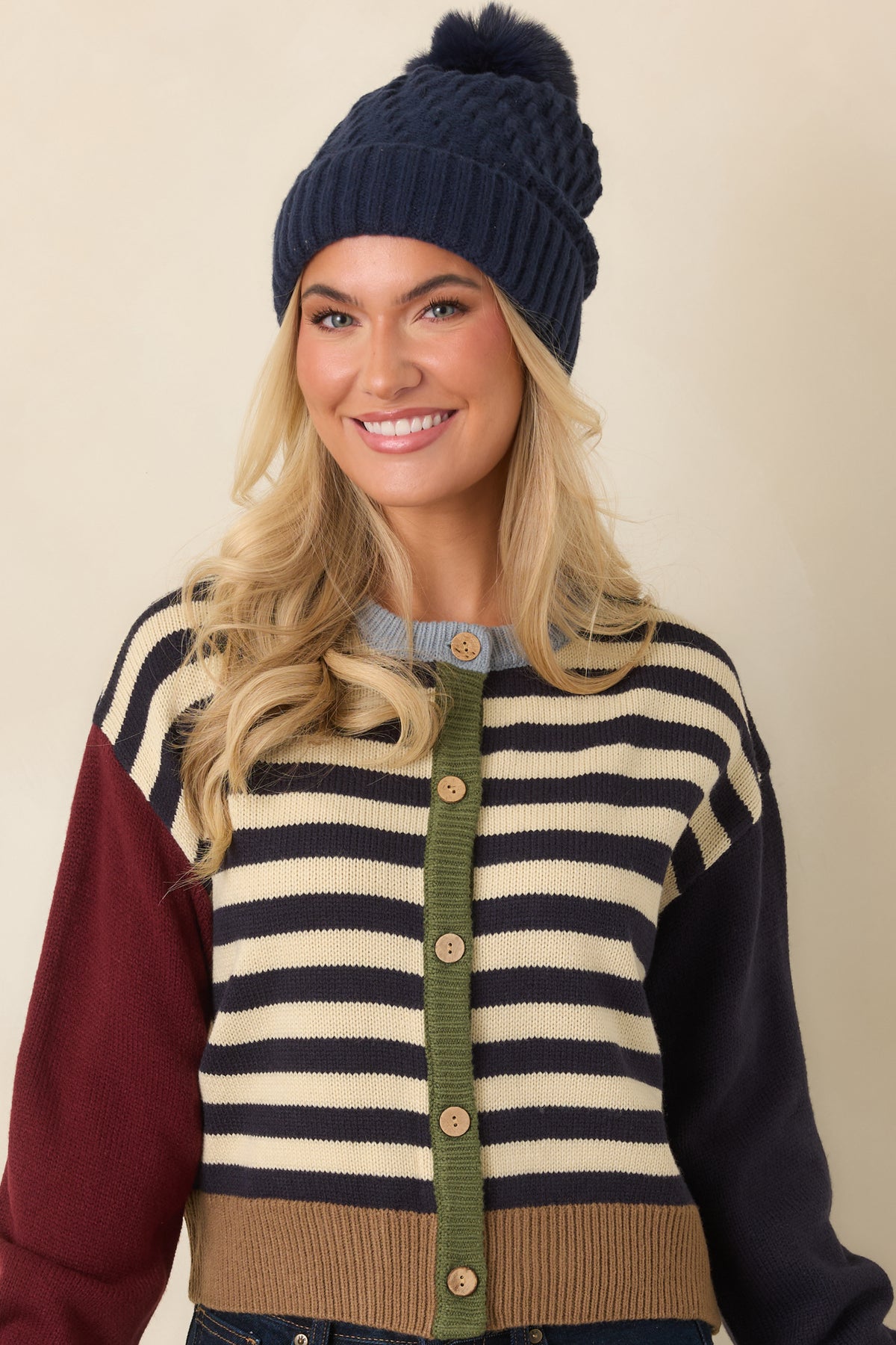 Camel ribbed hem and matching sleeve cuffs finish the relaxed navy and ivory striped cardigan.