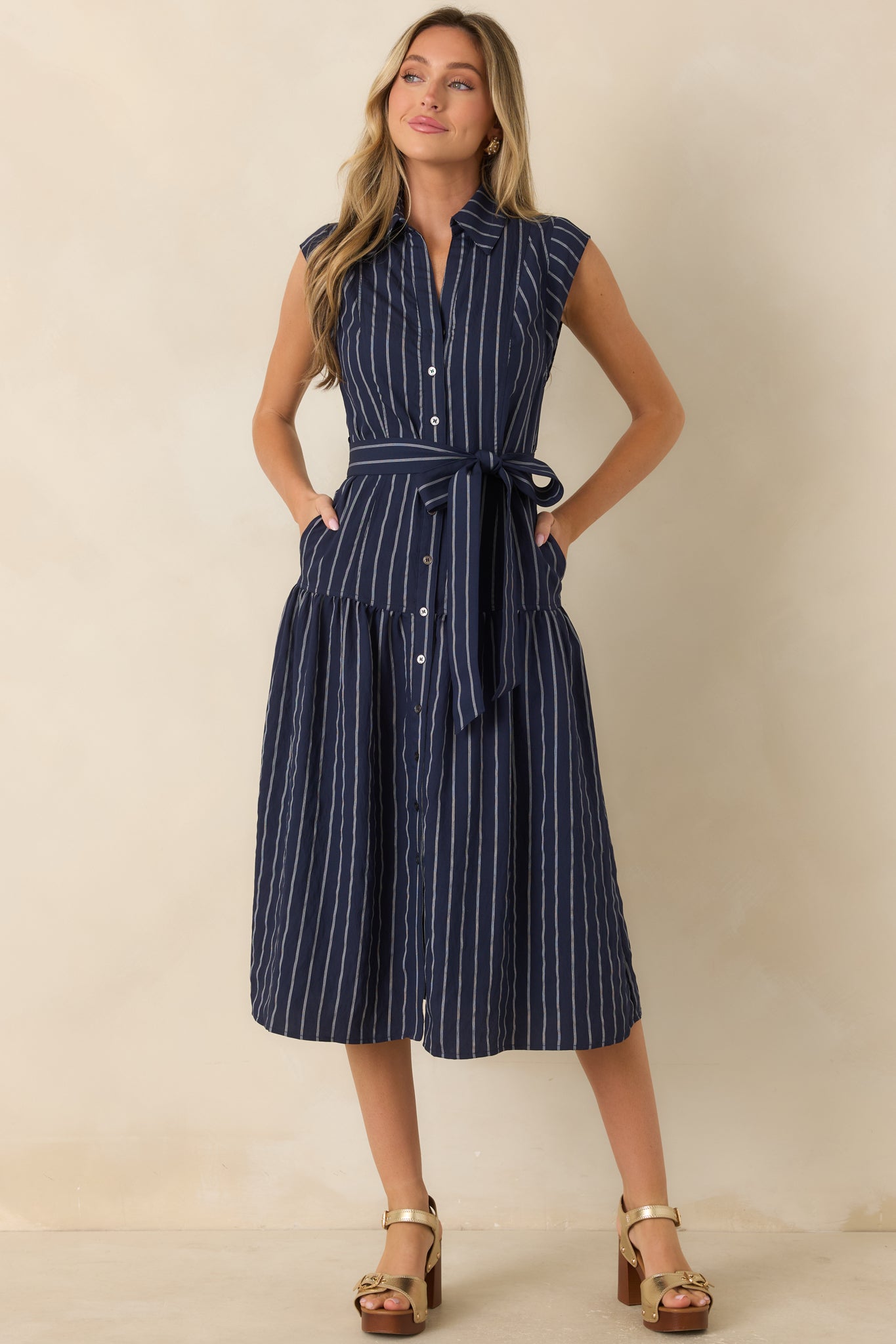 Striped woven midi dress featuring a collared neckline, button-front closure, removable waist tie, and full skirt.