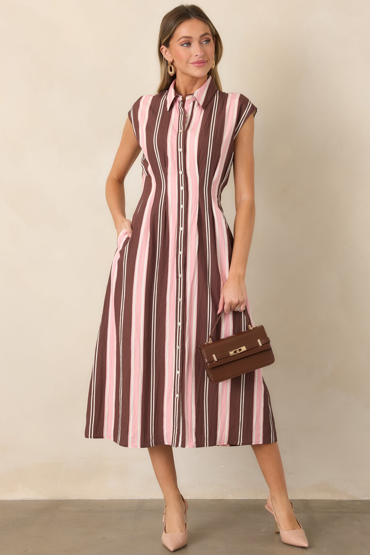Feminine striped midi dress with a structured collared bodice, short cap sleeves, tailored seams, and a softly flowing fit-and-flare skirt.