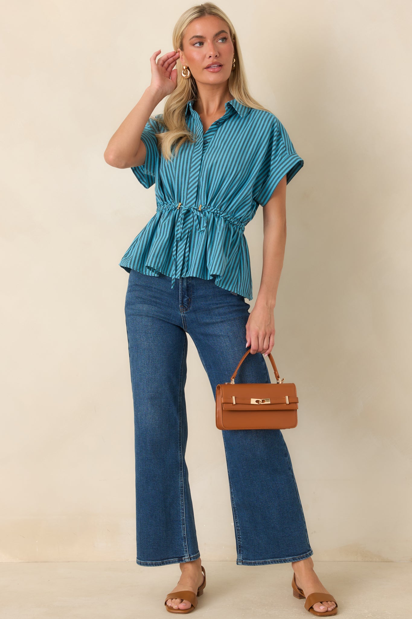Striped collared top featuring turquoise and charcoal vertical stripes, drawstring waist, and flared hem.
