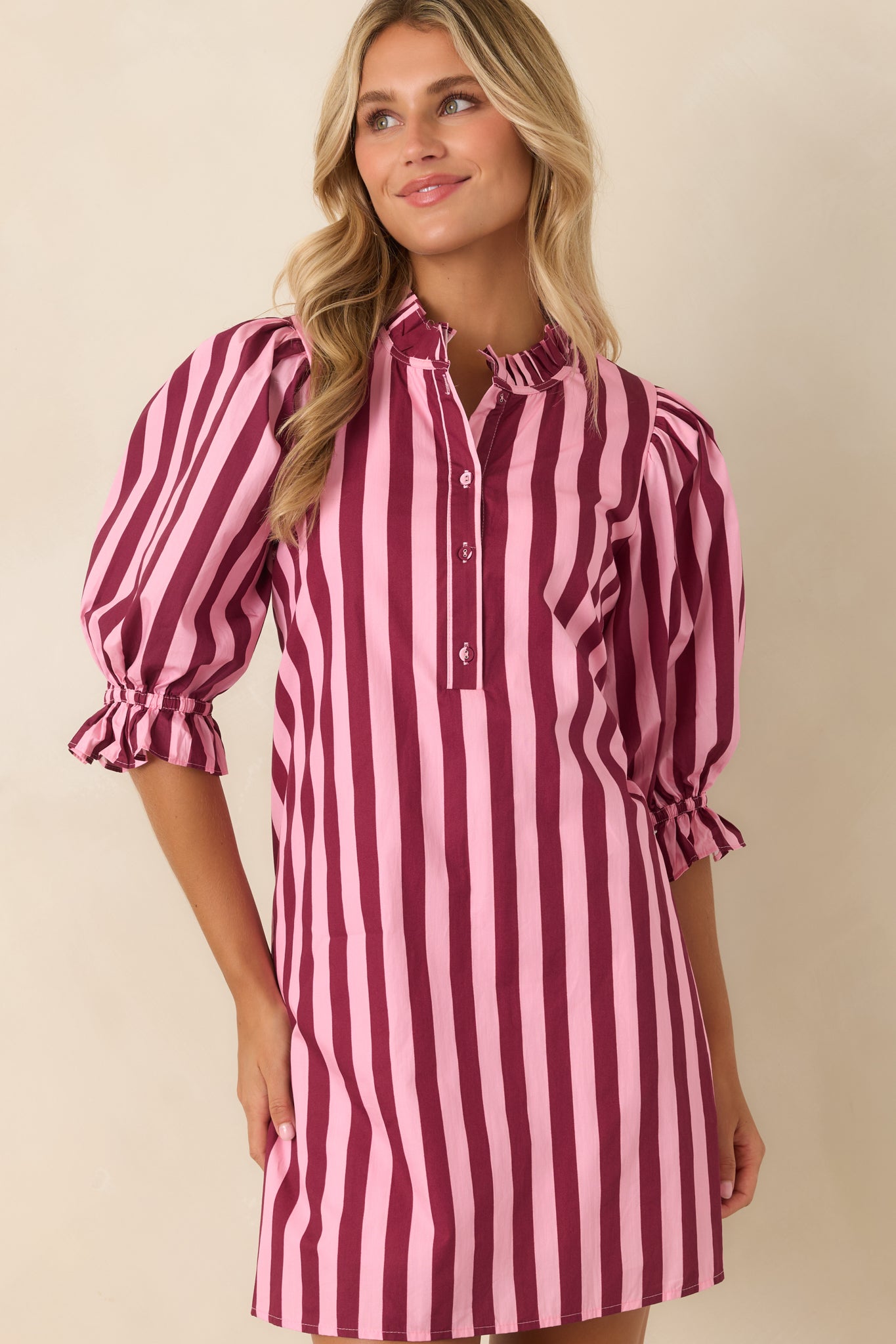 Striped cotton dress highlighting the adjustable drawstring waist, puff sleeves, and relaxed silhouette.