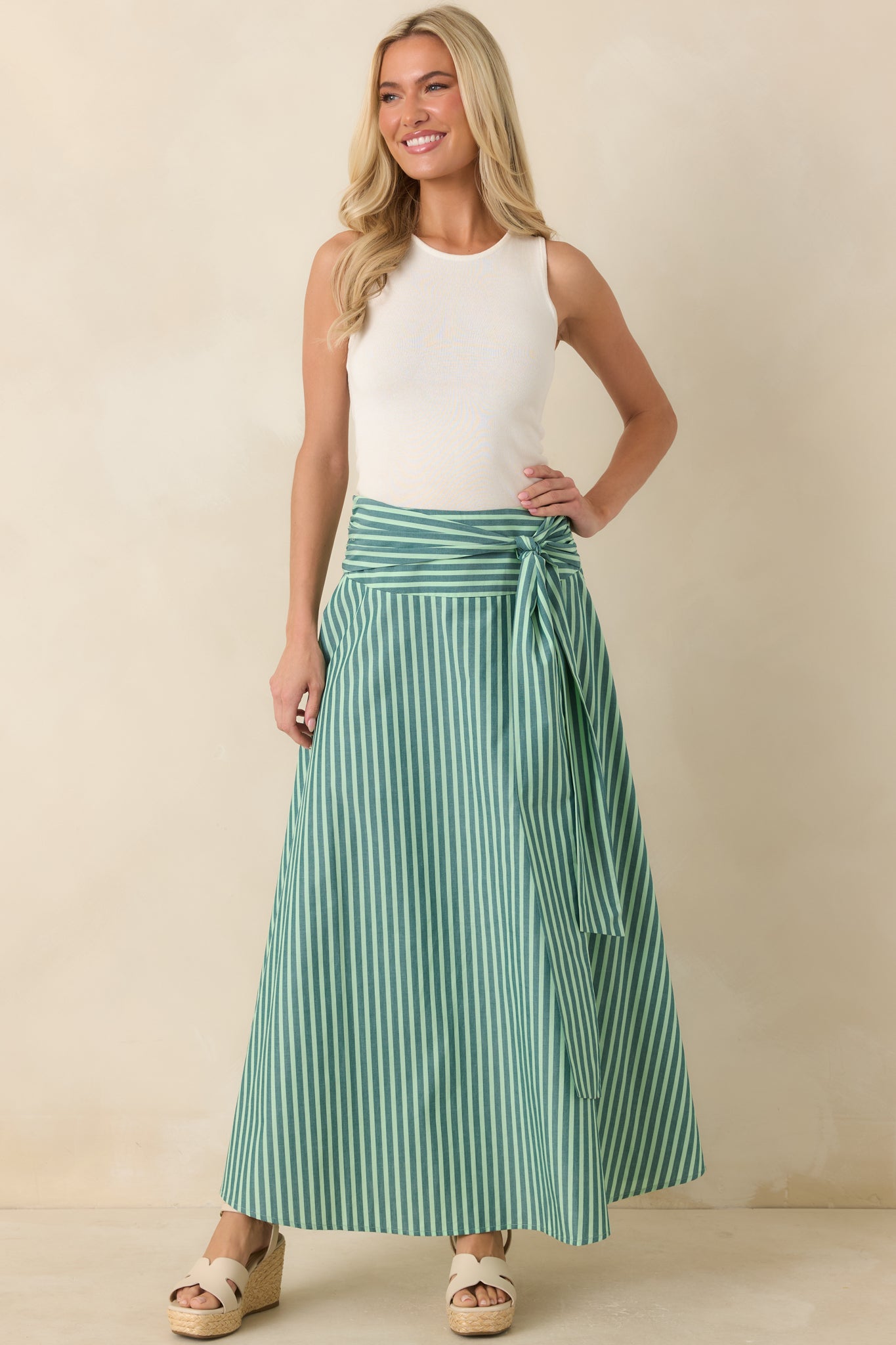 Thoughtfully placed stripes and gathered waist detailing enhance the flowing cotton maxi skirt with subtle texture and movement.
