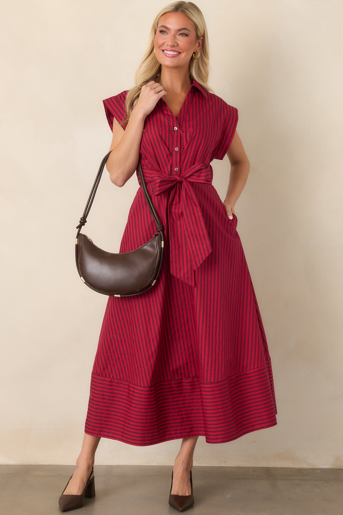 Striped cotton midi dress with a tailored silhouette, cap sleeves, collared neckline, and attached side ties forming a waist bow.