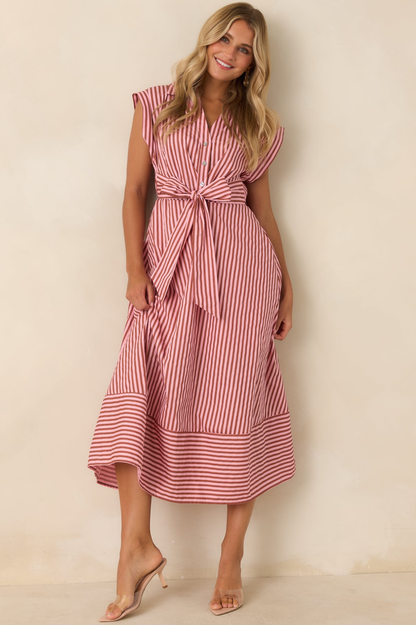 Striped cotton midi dress featuring a collared neckline, cap sleeves, partial button front, waist tie bow, and hidden pockets.