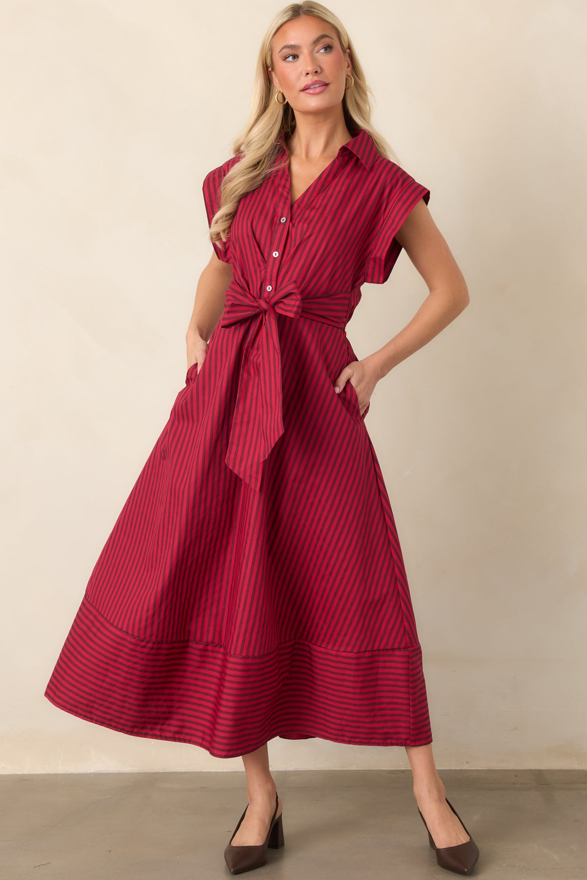 Striped midi dress crafted from crisp cotton with side ties, an elastic back waistband, and partial button-front closure.