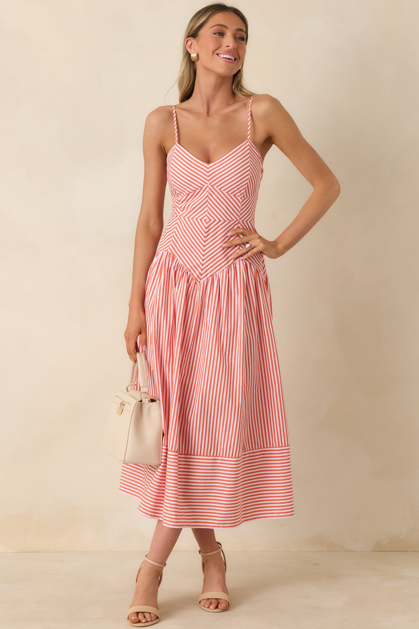 Fresh striped dress featuring slim spaghetti straps and a soft, airy silhouette.