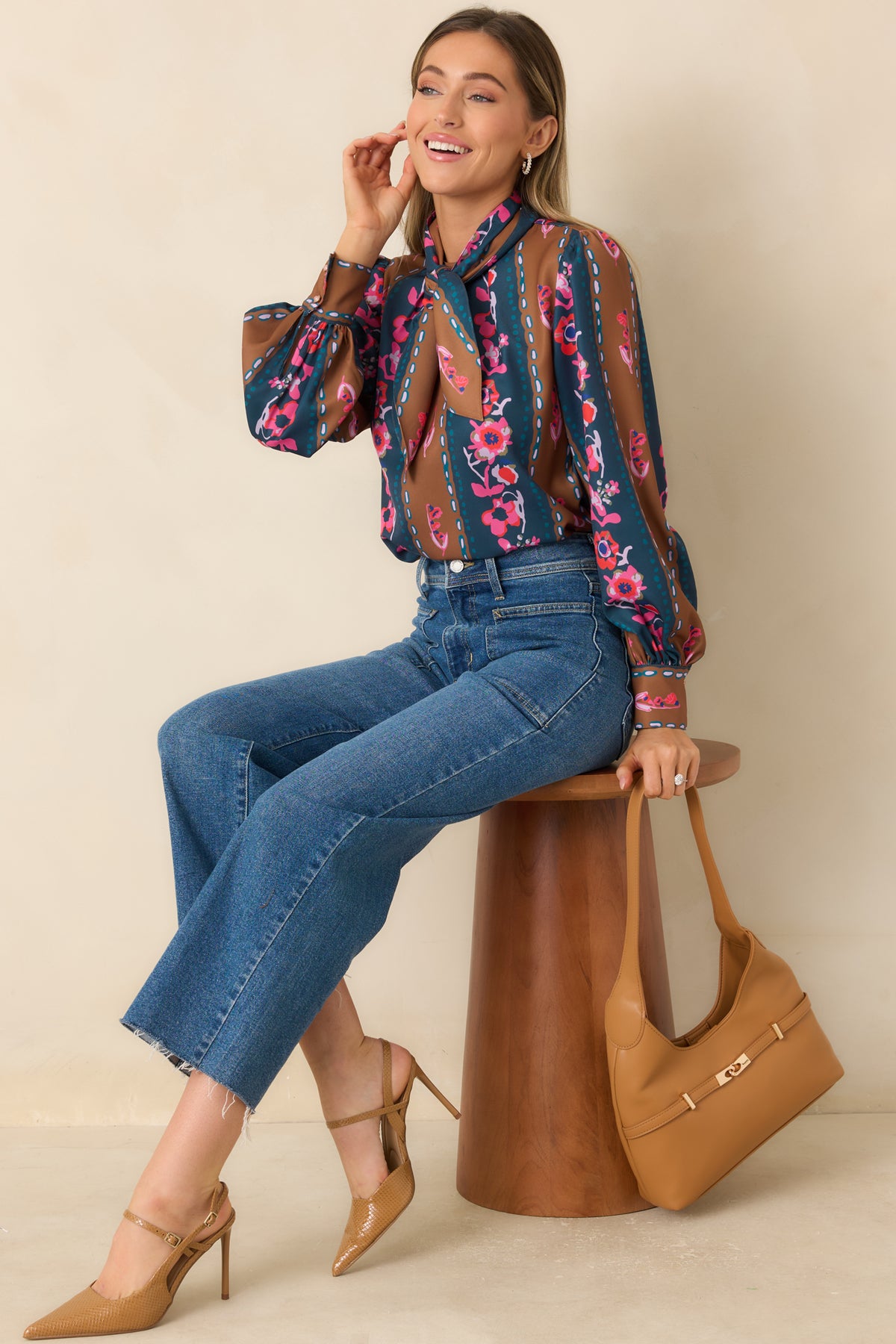 Striped floral top with a detachable neck tie, delicate chain-like motifs, and button-cuff sleeves.