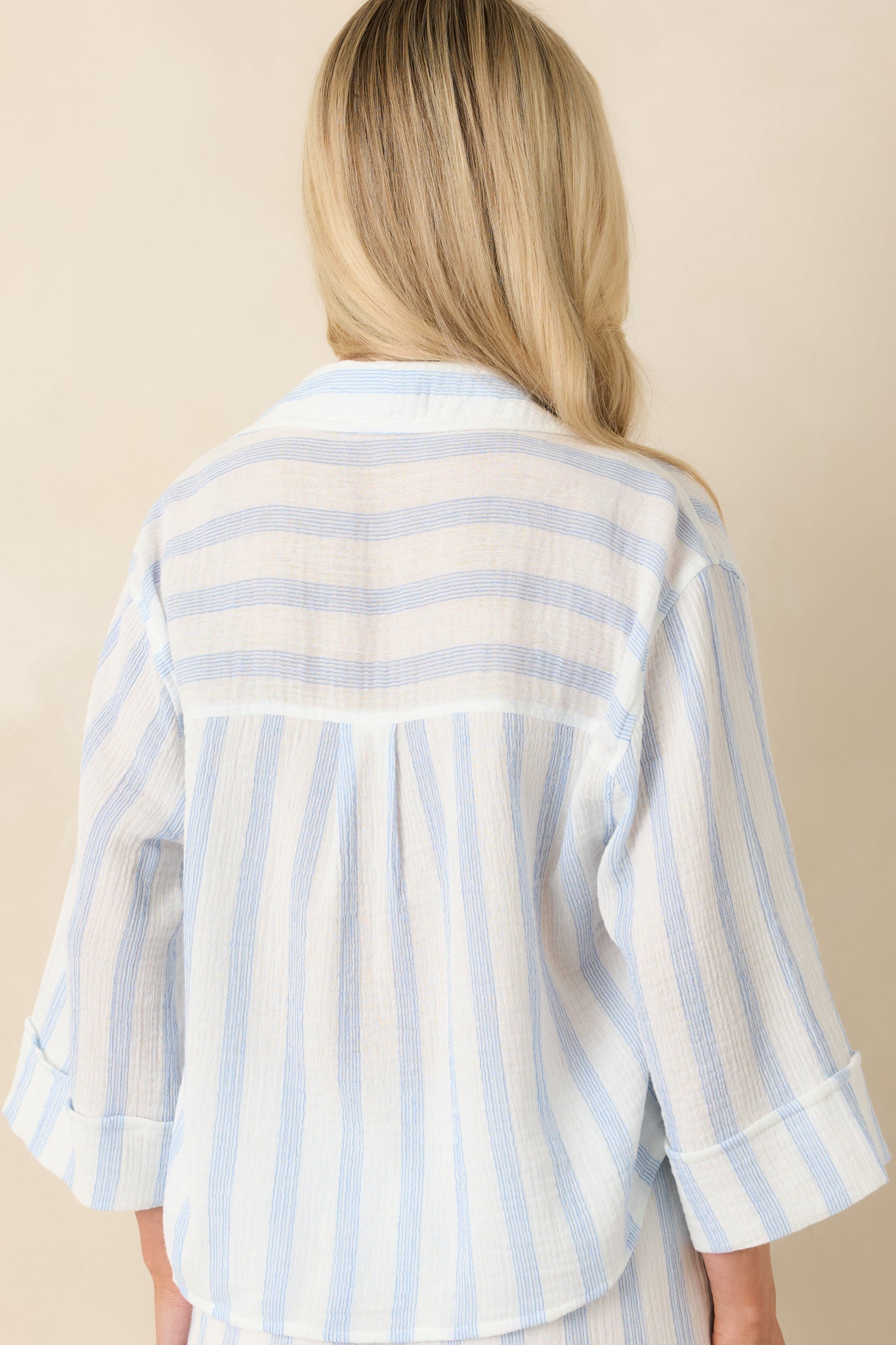 Back view of the striped gauze button-up top featuring the relaxed silhouette, lightweight fabric, and three-quarter sleeves.