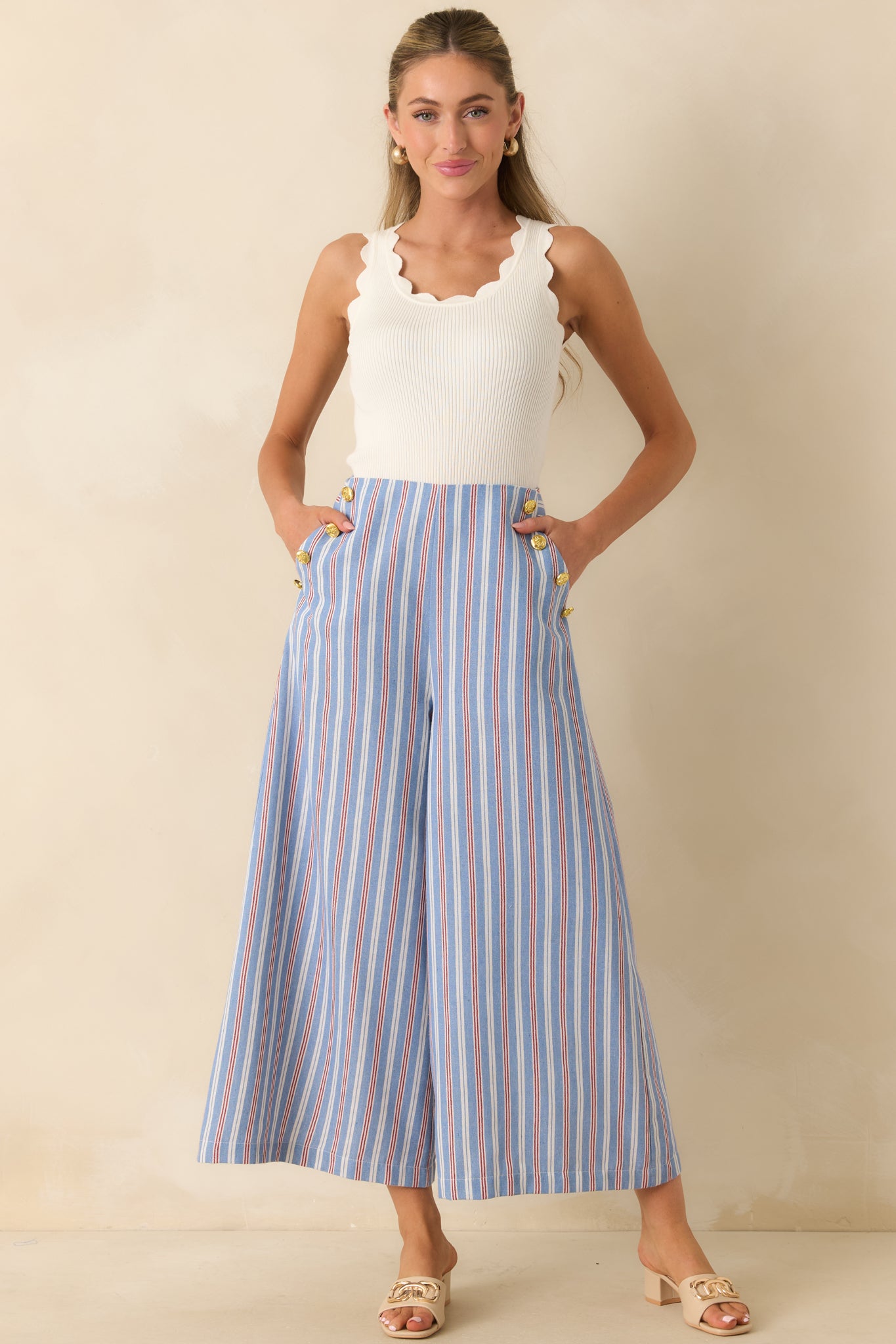Detailed view of the blue, red, and ivory striped fabric, highlighting the high-rise fit and gold-tone sailor buttons.
