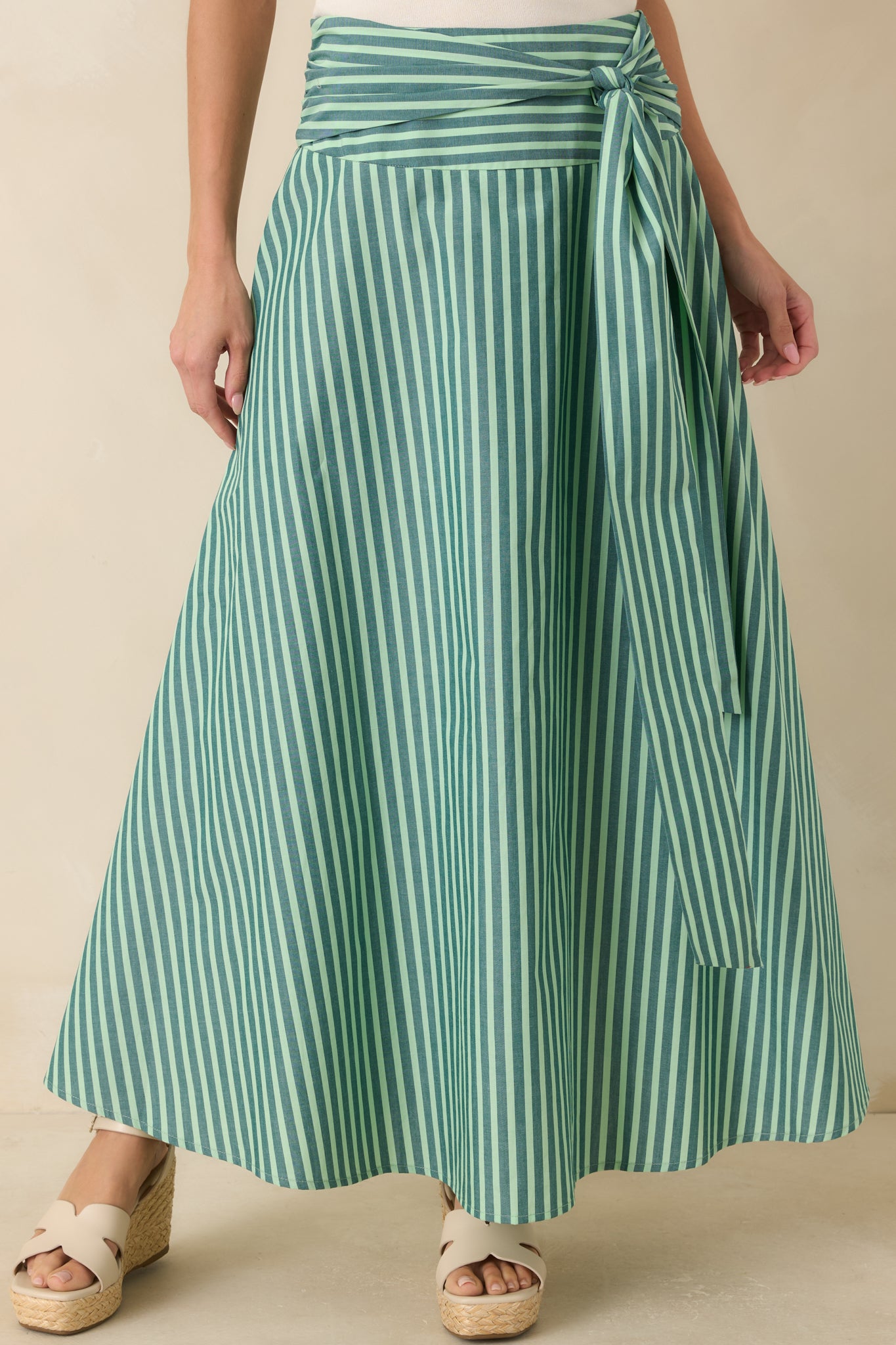 High-rise waistband accented by an oversized self-tie sash, highlighting the striped cotton fabric and flattering waistline.