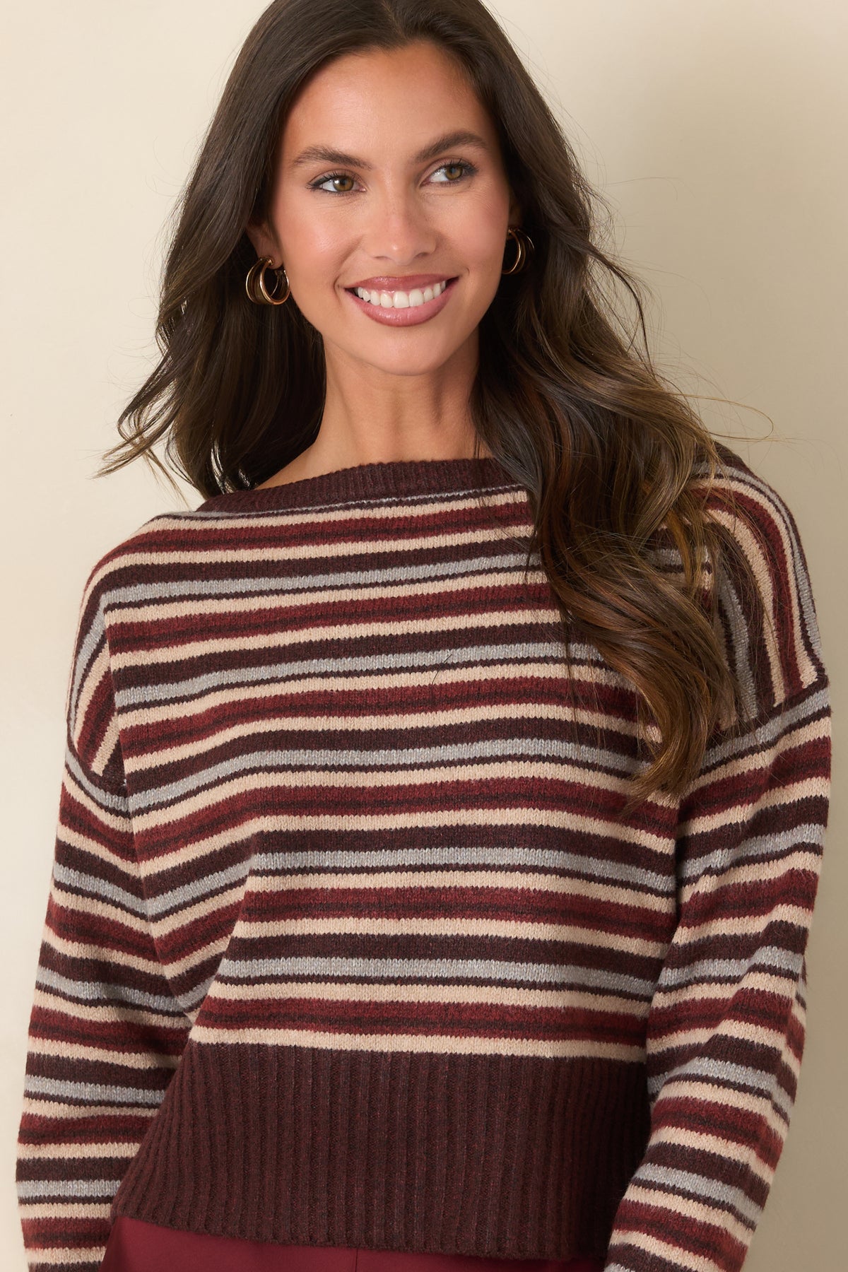 Striped knit top showcasing deep ribbed cuffs and long sleeves in a relaxed silhouette.