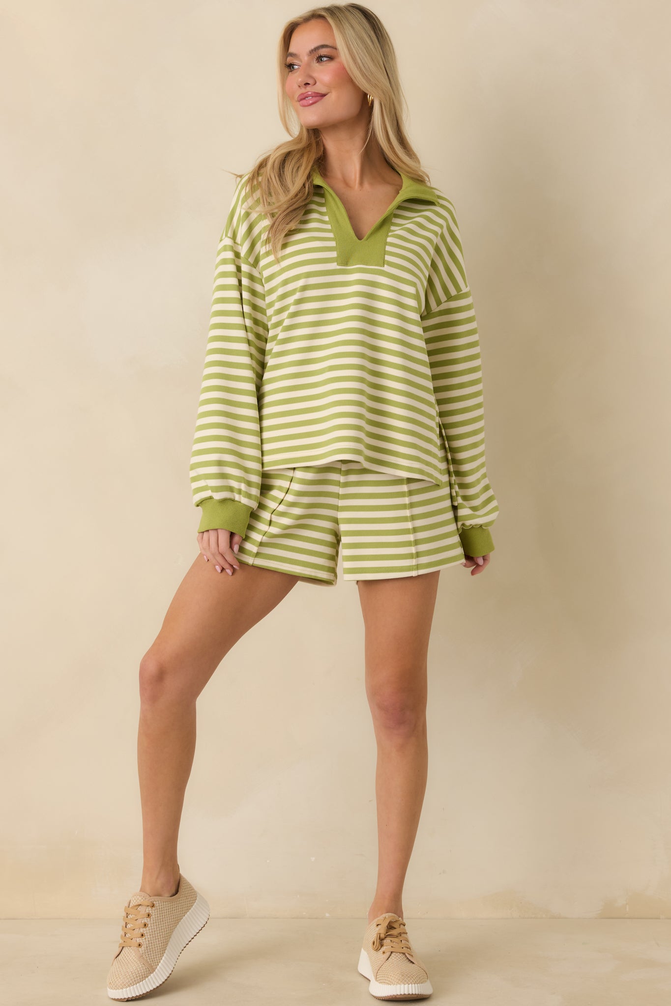 Green striped lounge top showcasing breathable knit texture and clean contrast neckline detailing.