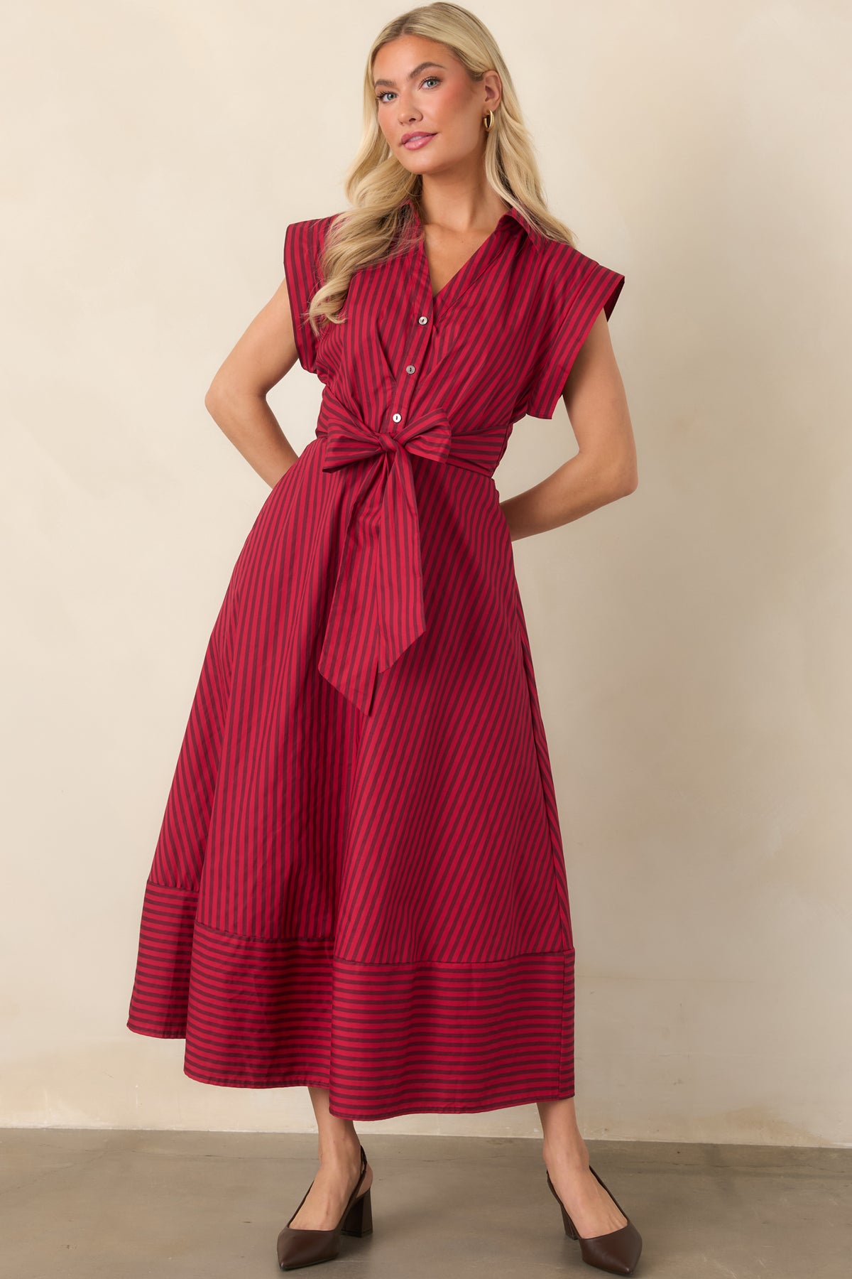 Striped midi dress with a tailored bodice, partial button placket, cap sleeves, and coordinating waist ties.