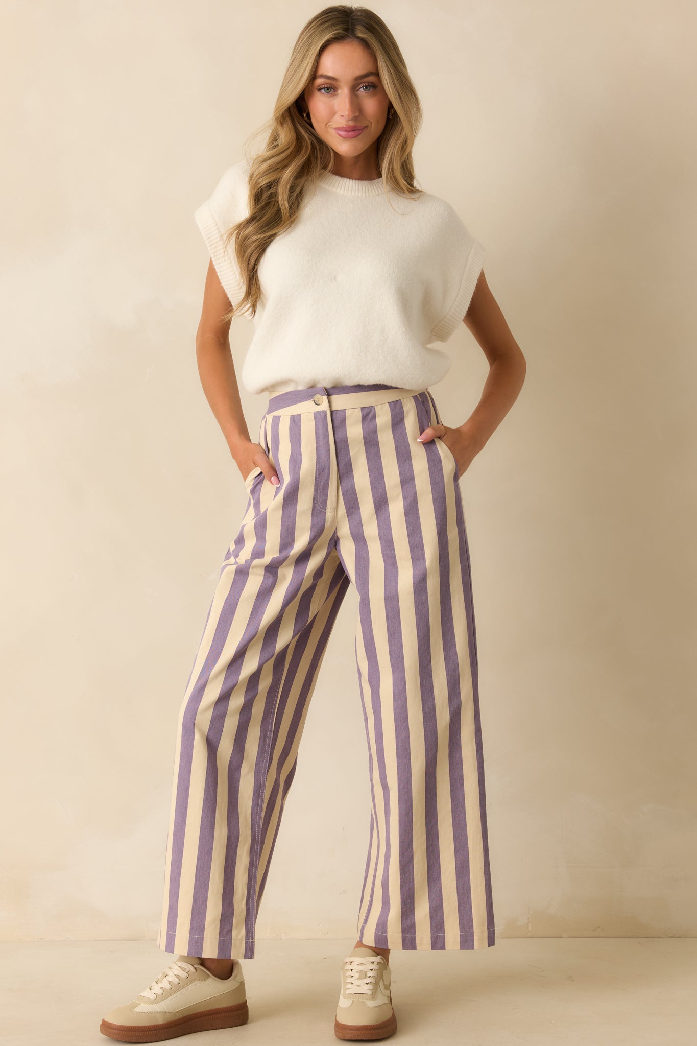 High-waisted striped pants displayed buttoned and zipped, showcasing their flattering wide-leg shape.