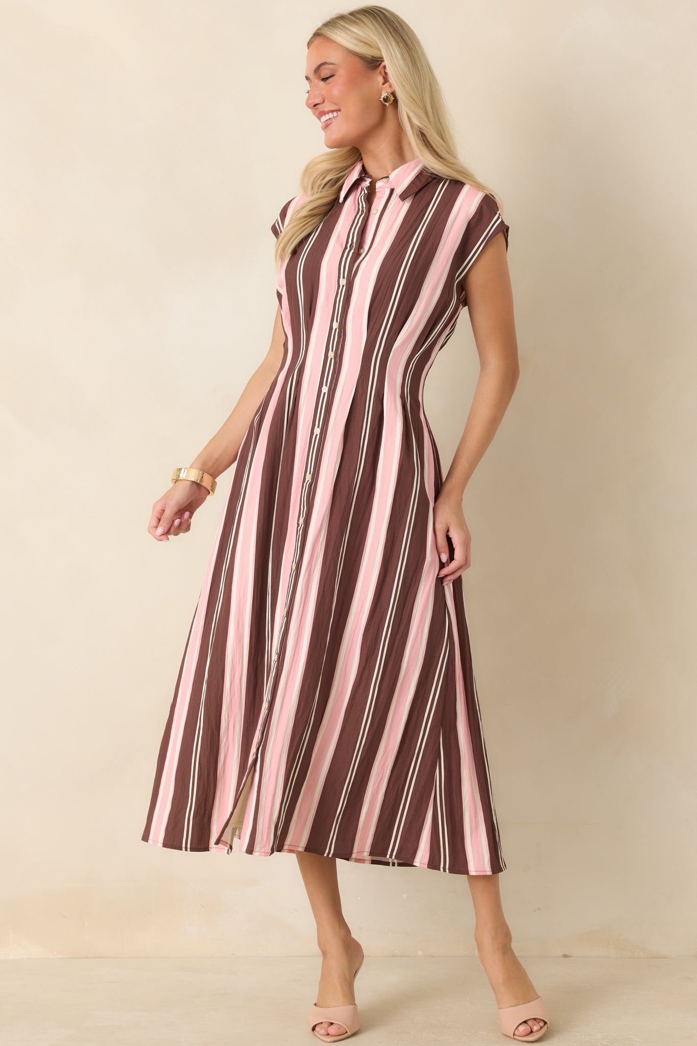 Soft vertical striped midi dress showcasing tailored princess seams, a feminine silhouette, and classic shirt dress styling.