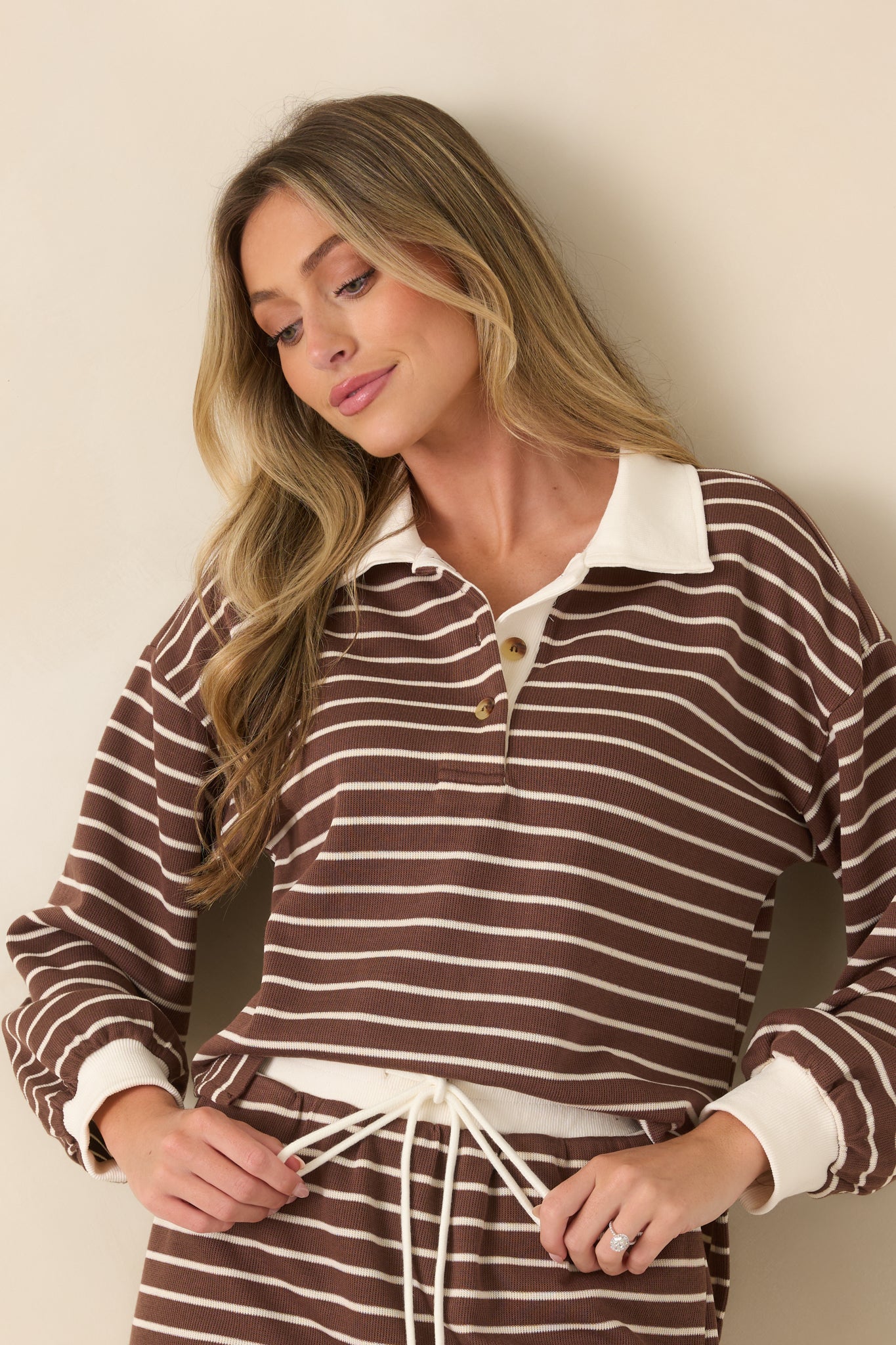 Close view of the striped pullover highlighting the contrast ivory collar and partial button placket.