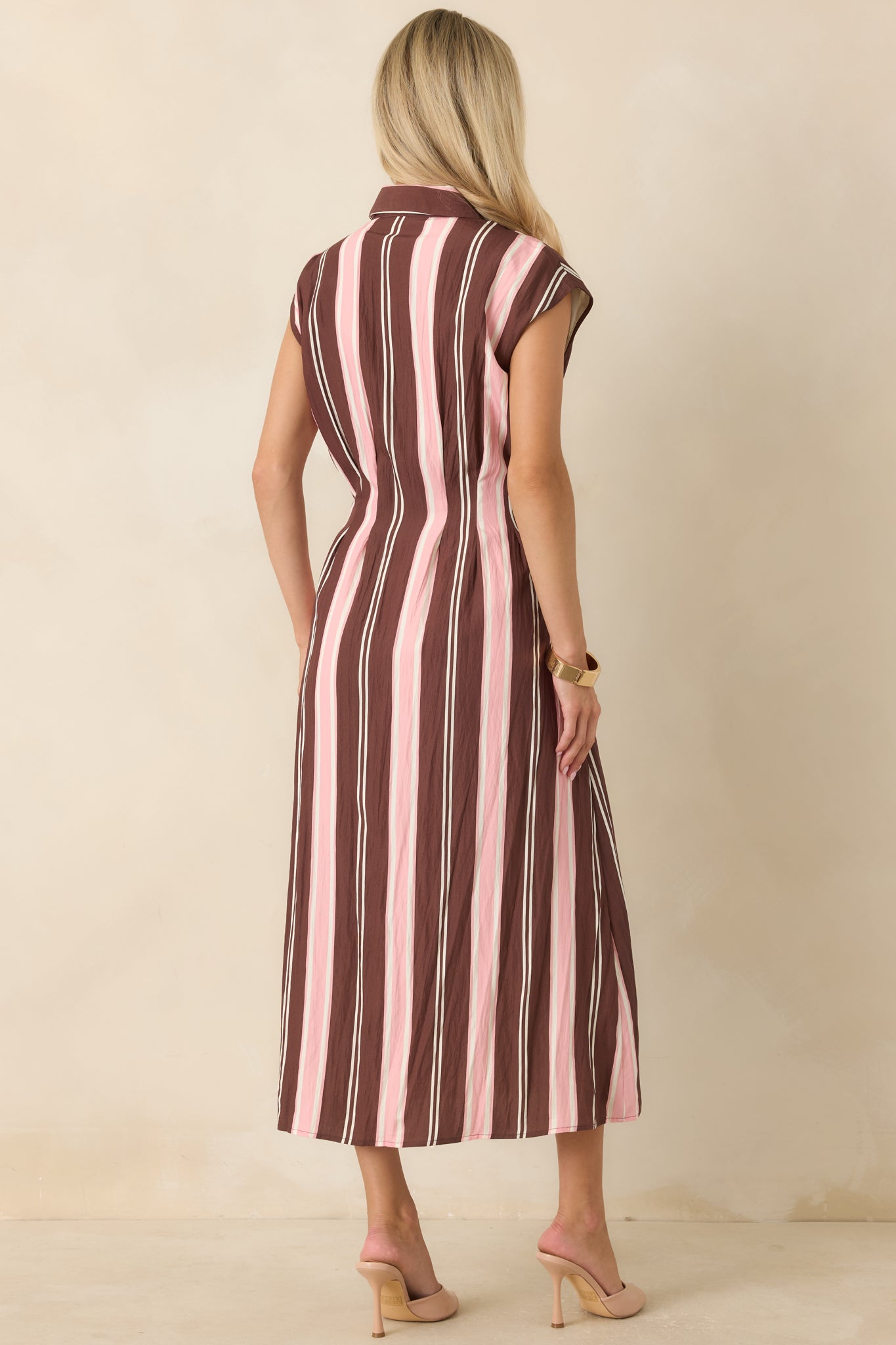 Rear view of the striped midi dress featuring a fit-and-flare silhouette, cap sleeves, and structured shaping.