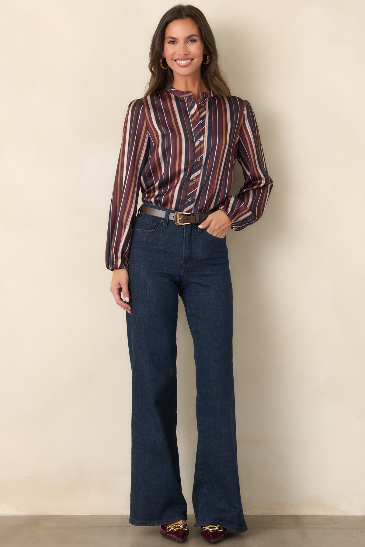 Striped satin top with a band collar, long balloon sleeves, and gently curved hem.