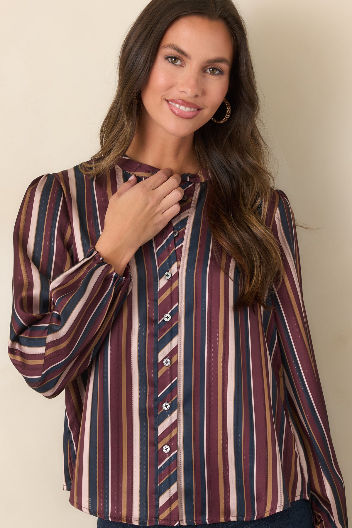 Striped satin top showcasing the diagonal pattern along the button placket.