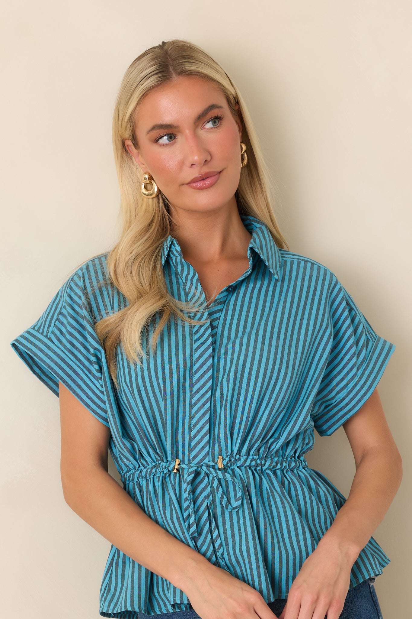 The front of this striped top highlights the collared neckline, vertical stripes, and drawstring waist.