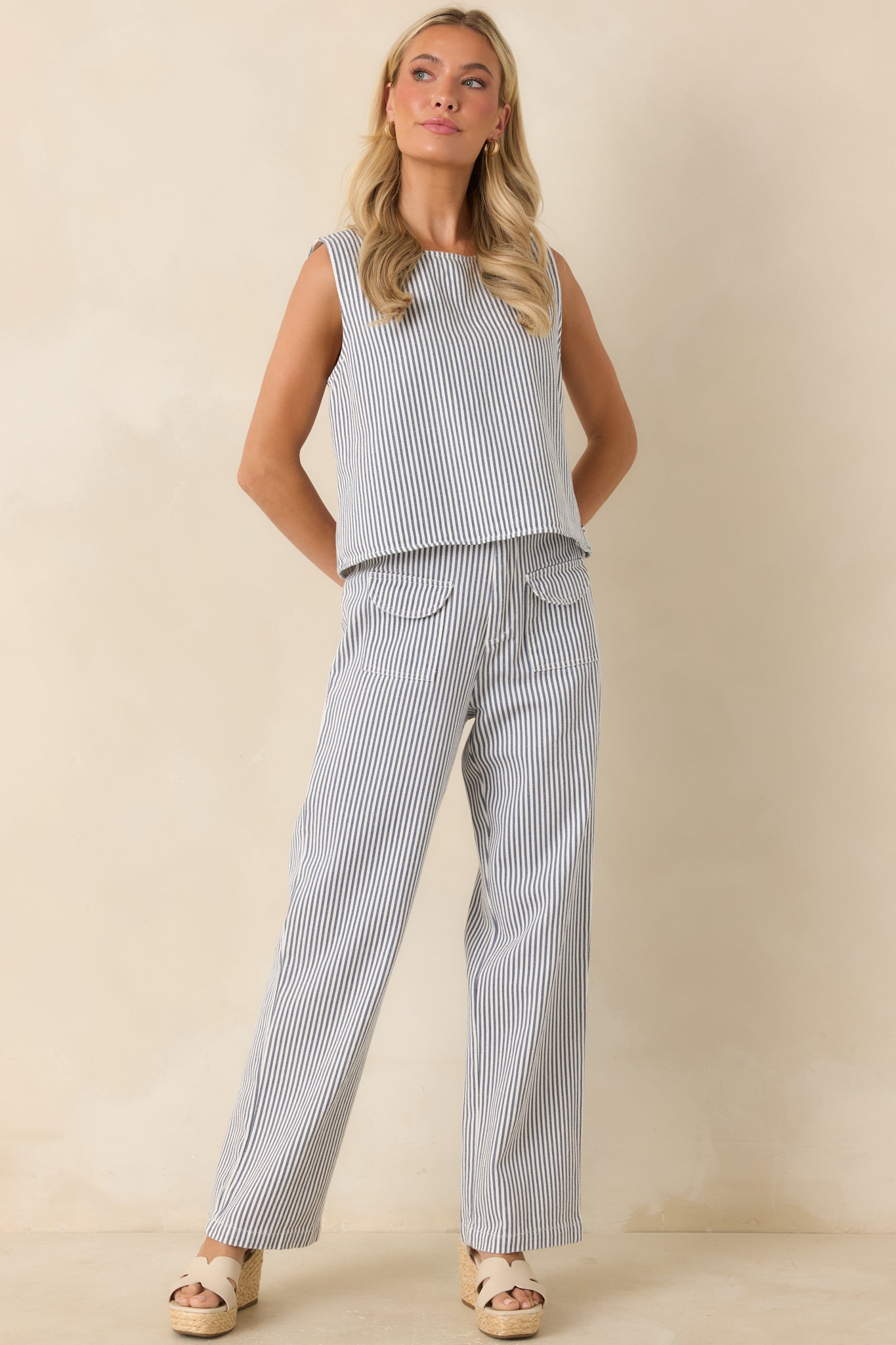 Blue and ivory striped pants highlighting the relaxed wide leg silhouette and lightweight texture.