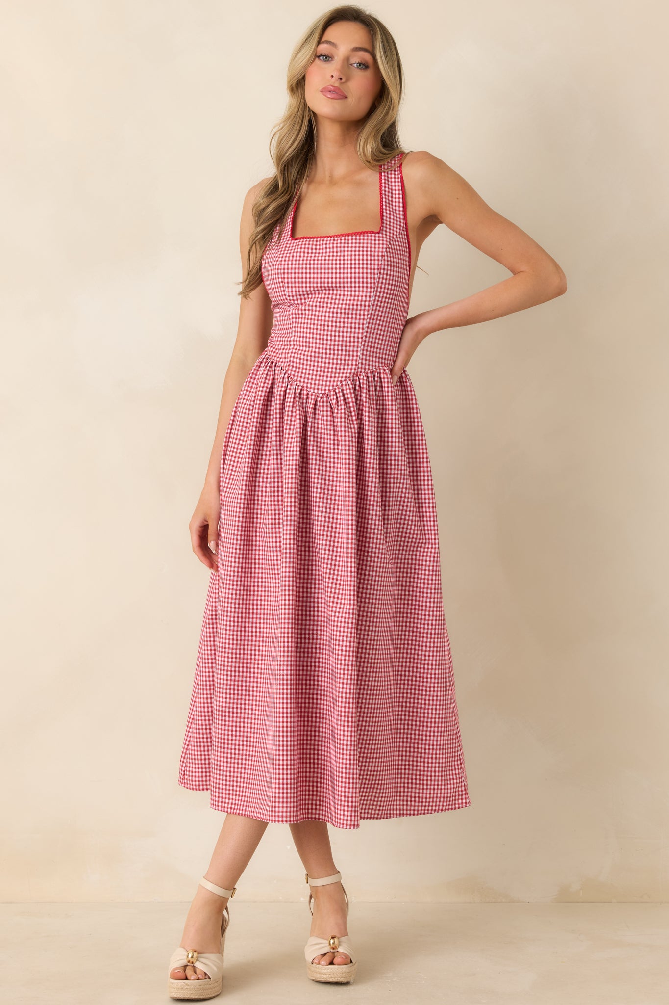 Structured bodice dress with wide straps and relaxed, breezy skirt movement.
