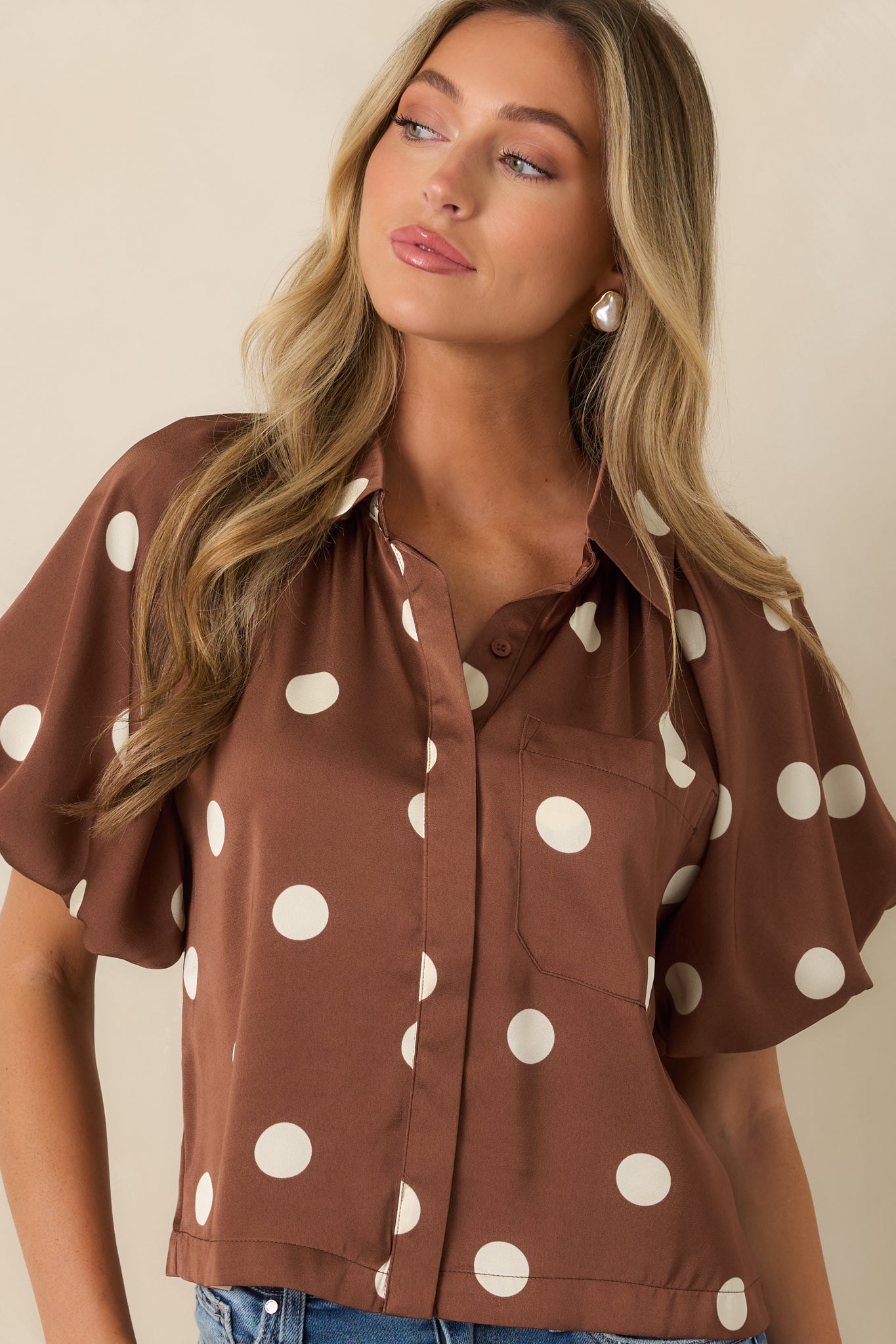 Detailed view of the structured collar and concealed button-front placket showcasing the blouse's polished design.