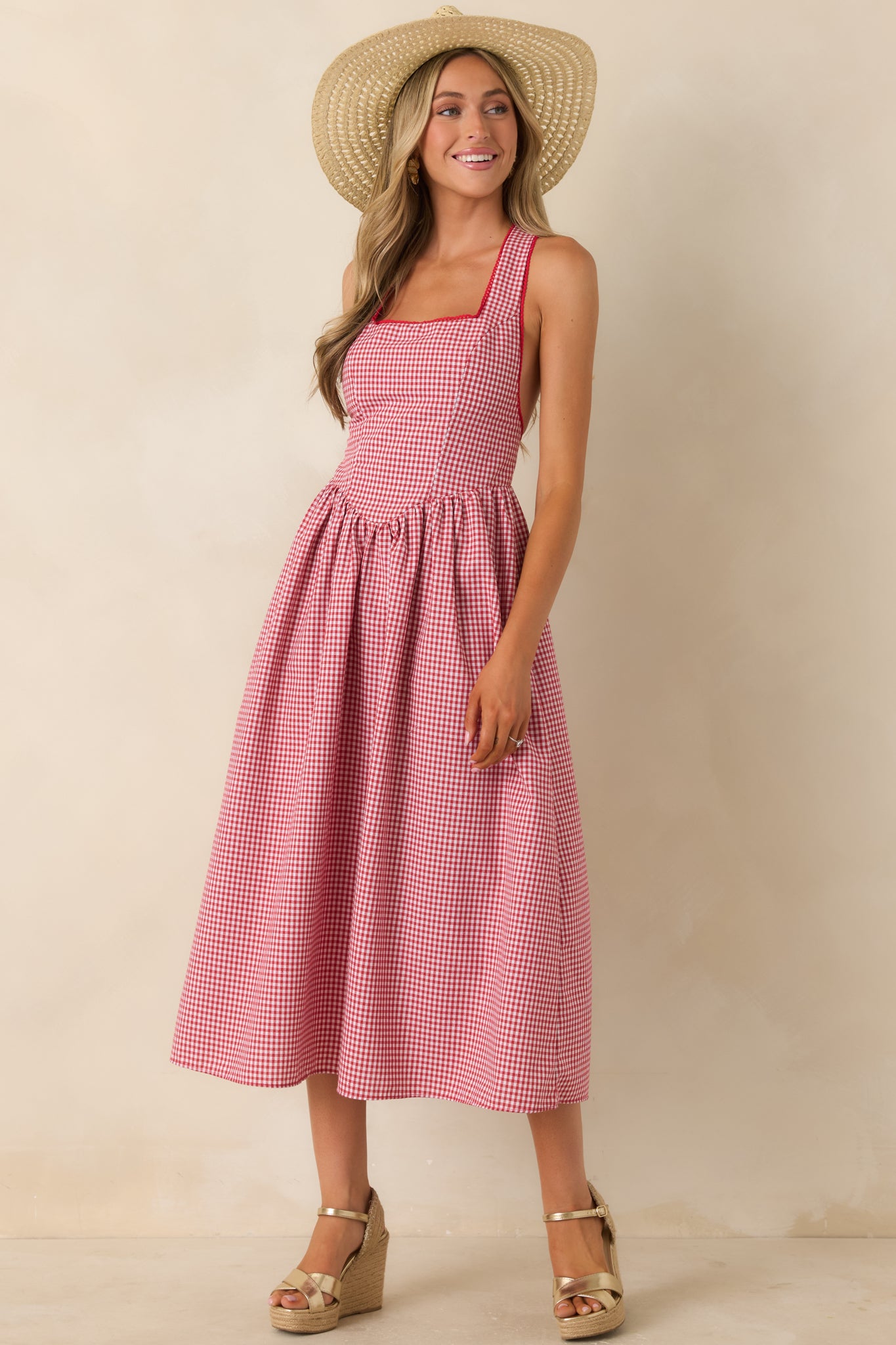 Structured cotton dress with wide straps and softly gathered skirt silhouette.
