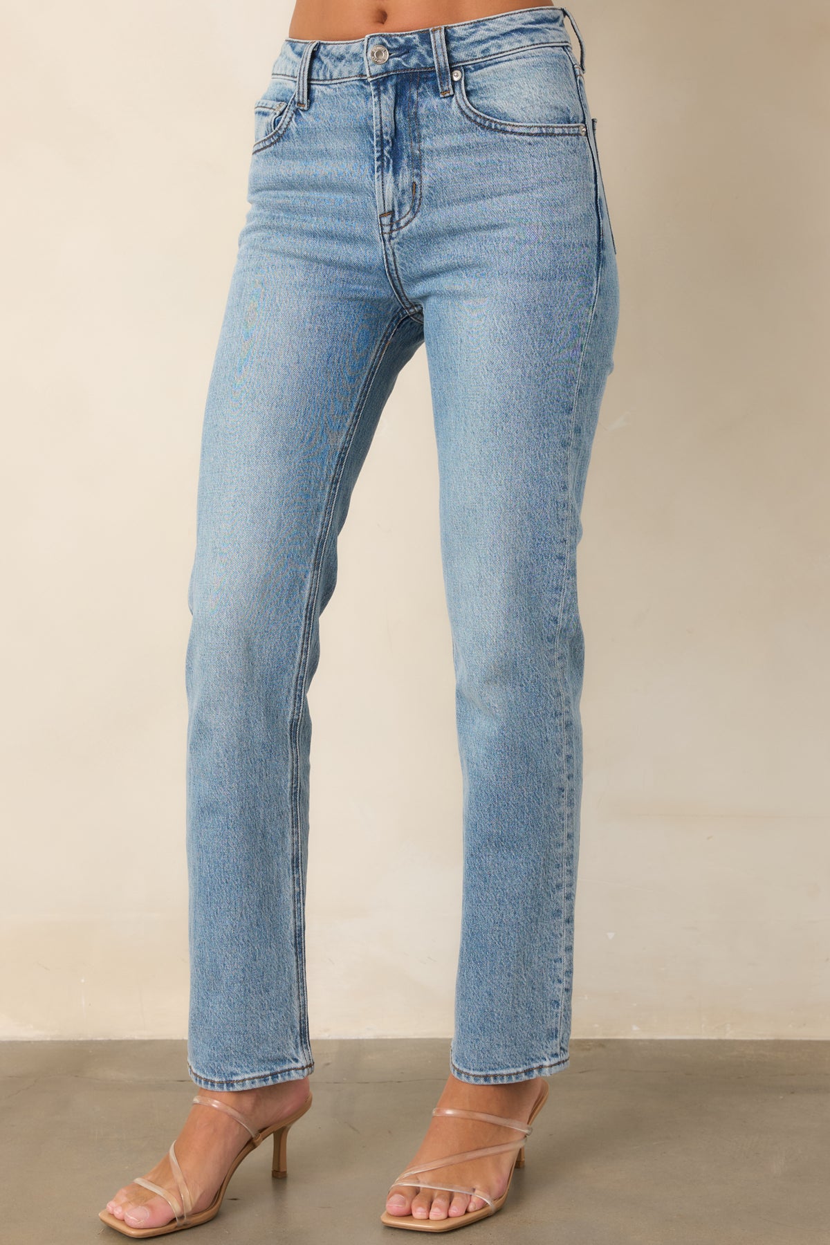 Structured denim jeans highlighting the classic five-pocket design and high-rise waist.
