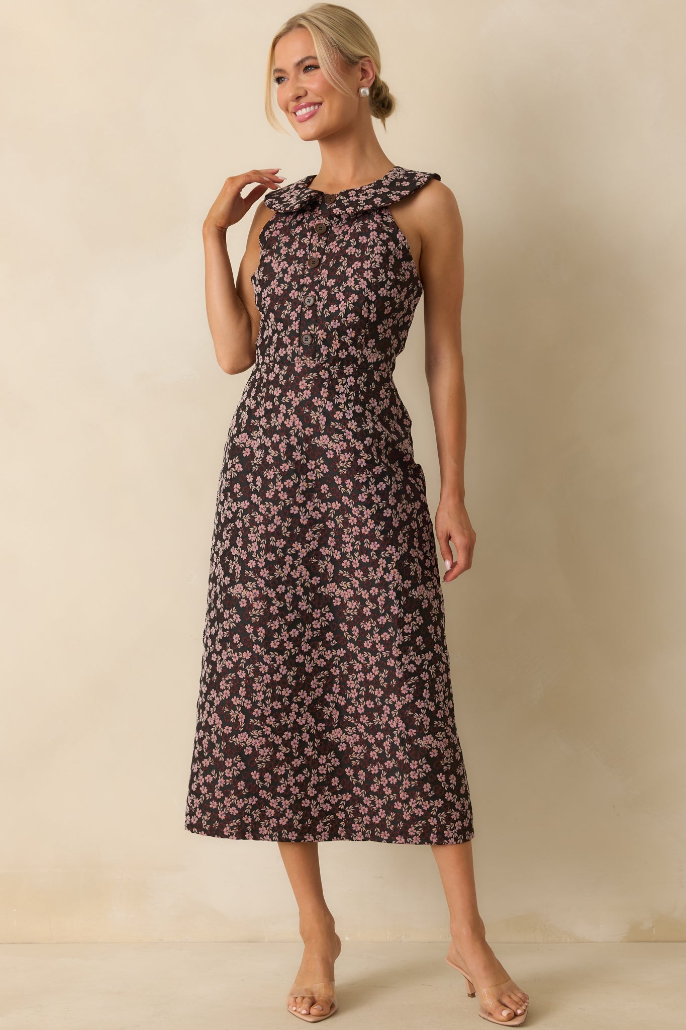 Structured floral midi dress with black base, faux button front, and refined shape.