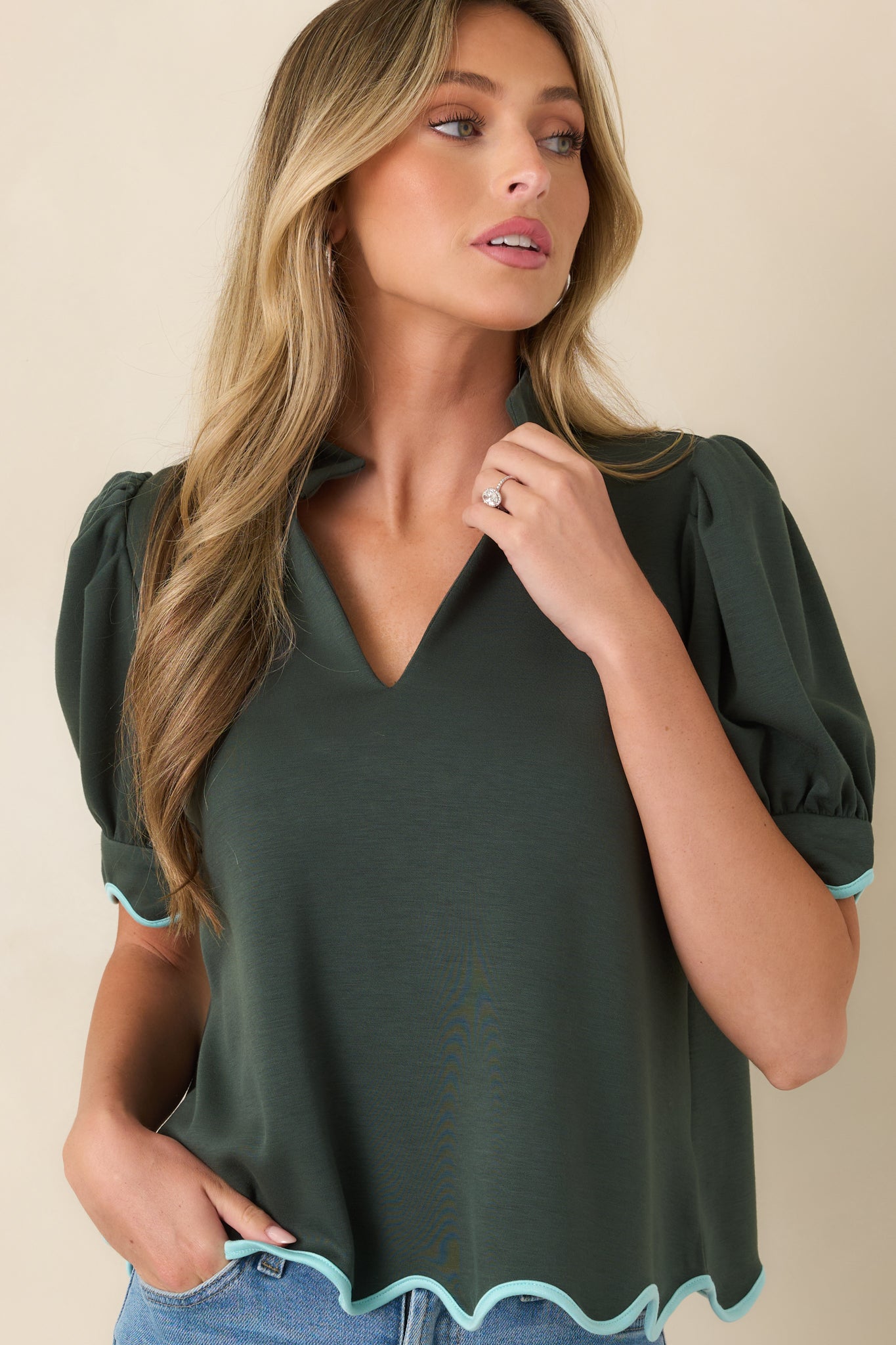 Soft structured knit fabric and a relaxed fit define this elevated green top.
