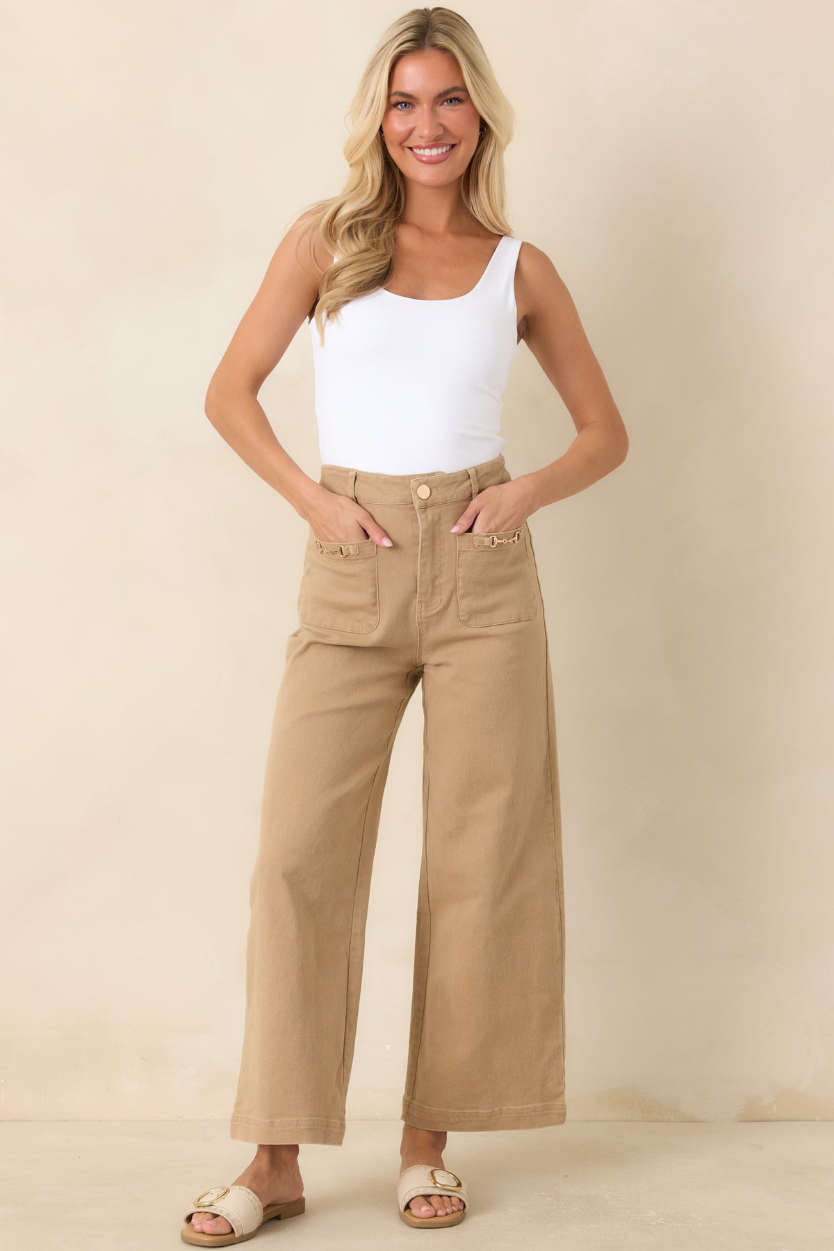 Structured high-rise pants with oversized front pockets, belt loops, and a clean ankle-length finish.