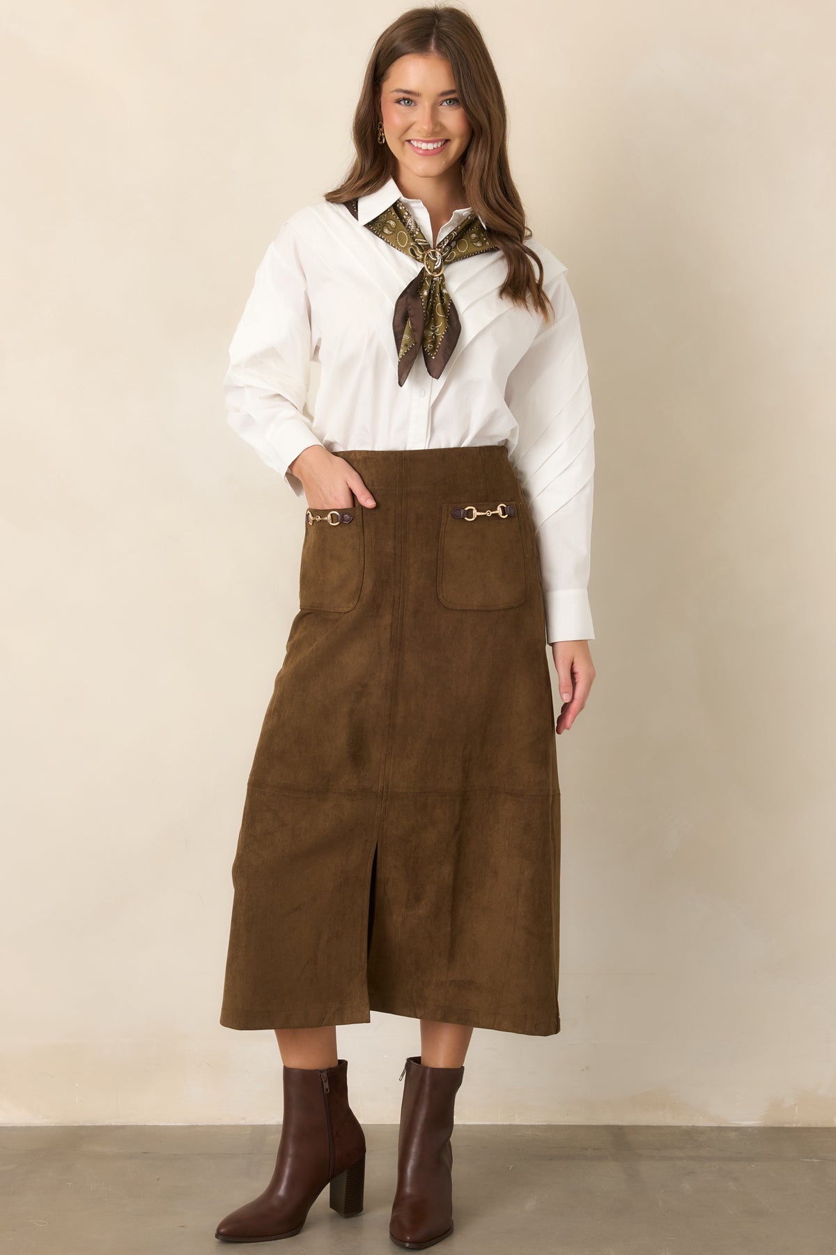 Structured midi skirt with decorative gold-tone hardware, front pockets, and a center-front slit.