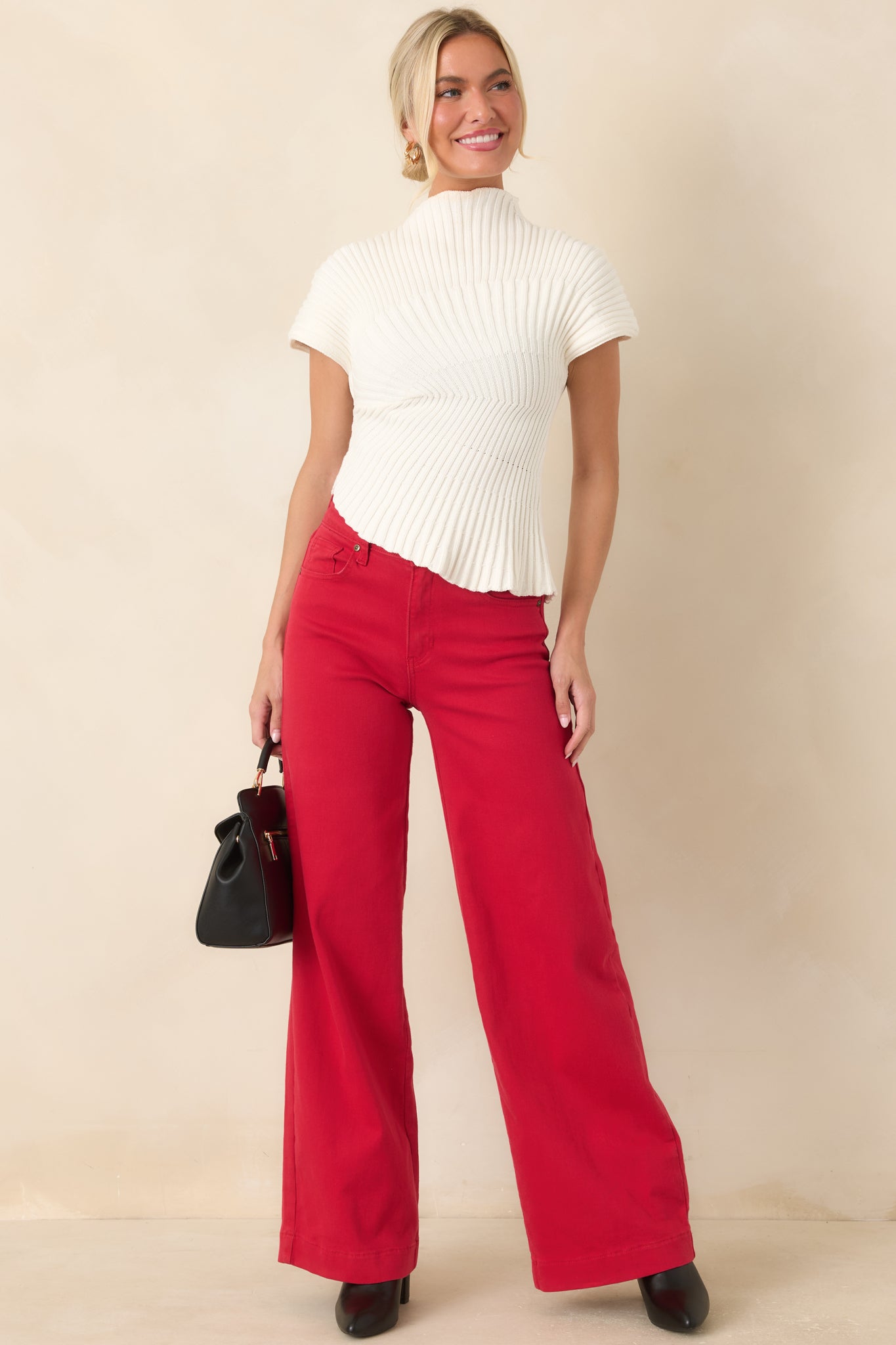 Structured ribbed knit top showcasing short cap sleeves, a high neckline, and a sleek fitted shape.