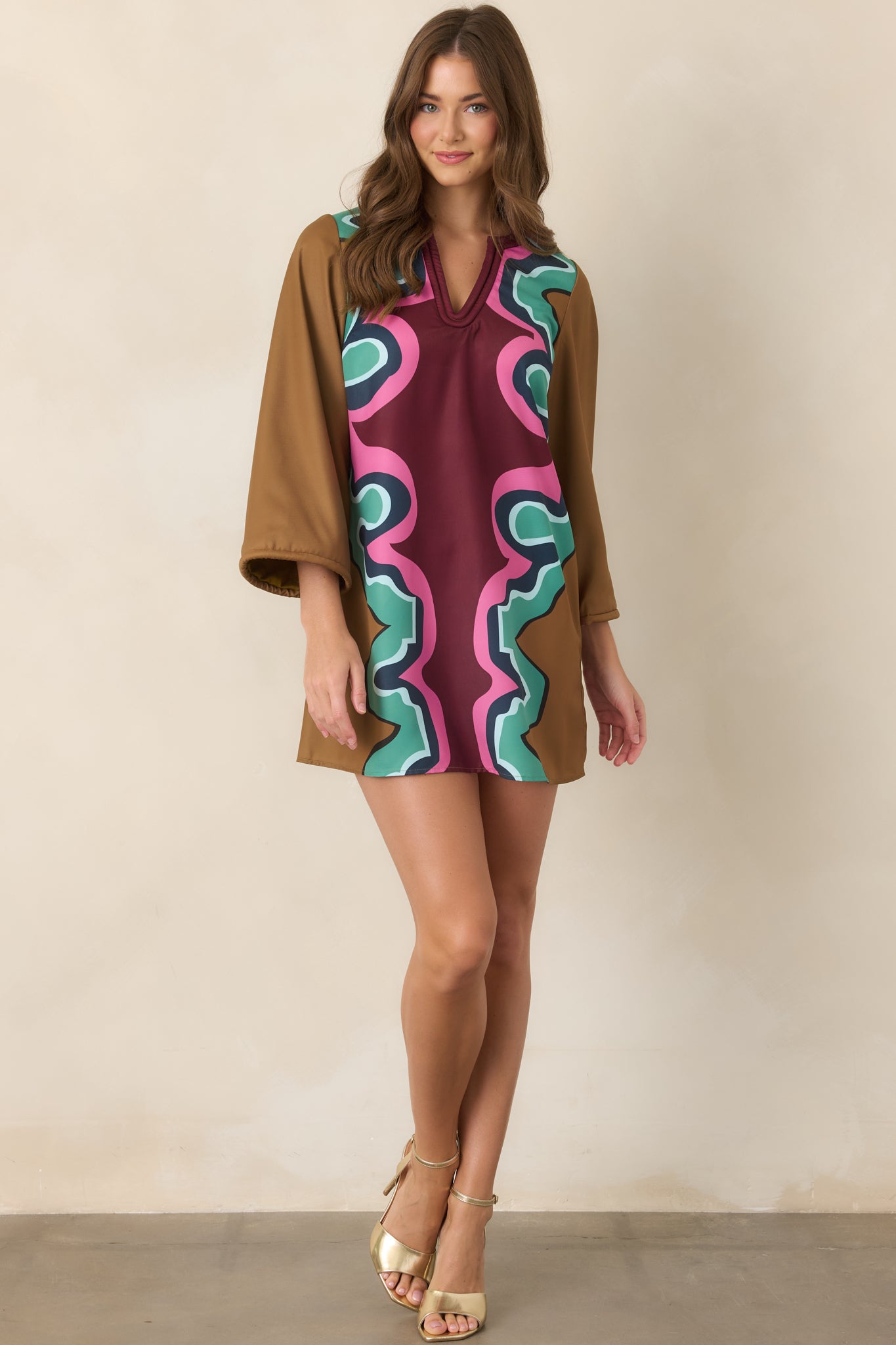 Statement A-line mini dress with a structured drape, subtle sheen, corded neckline, and wide three-quarter sleeves finished with coordinating trim.