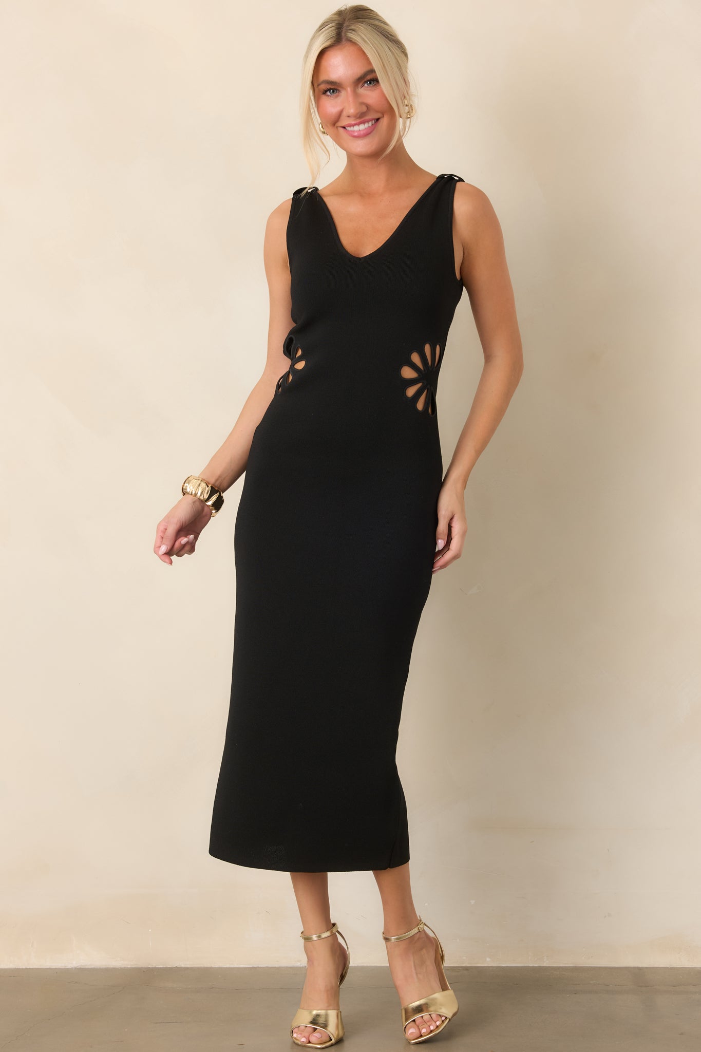 Sleek midi dress crafted from substantial stretch knit, designed with a smooth fitted shape and open floral details at the sides.