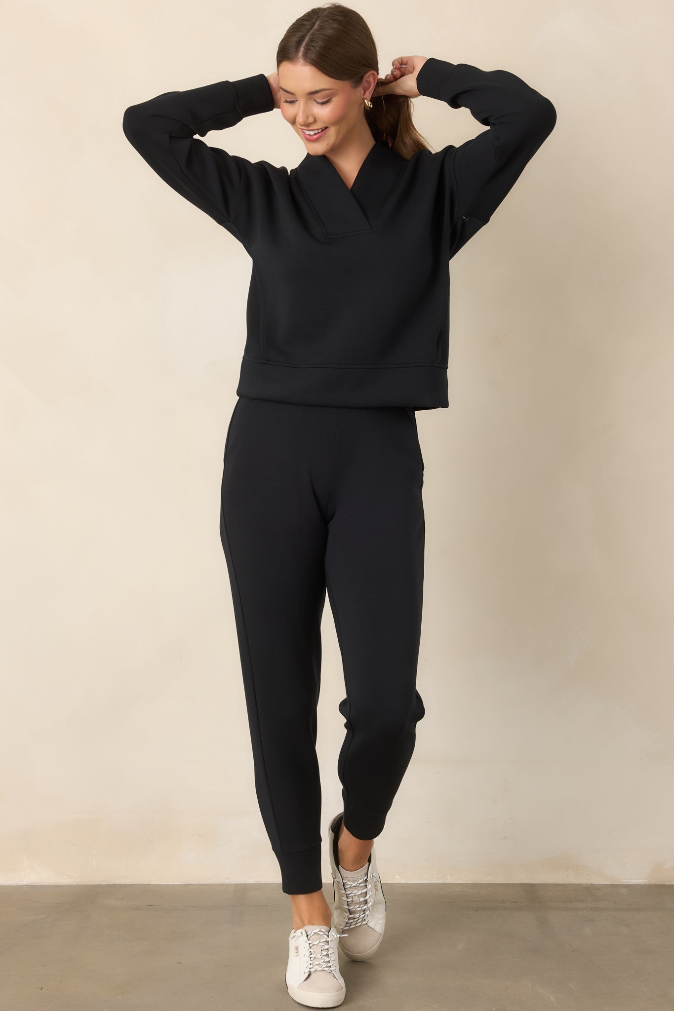Structured top with a wide collar framing the V-neckline and relaxed long sleeves with banded cuffs.