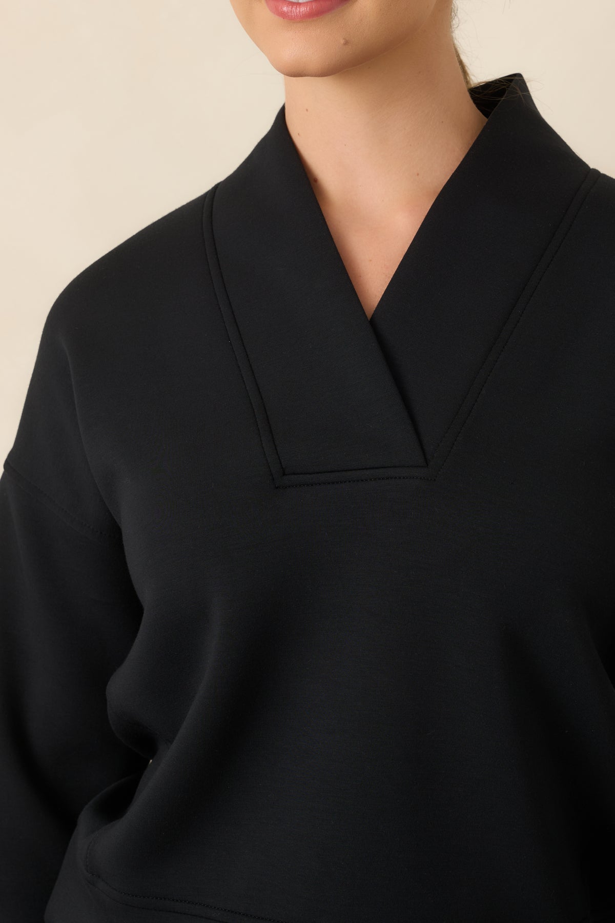 Close-up of the structured V-neckline and wide collar detailing at the upper top.